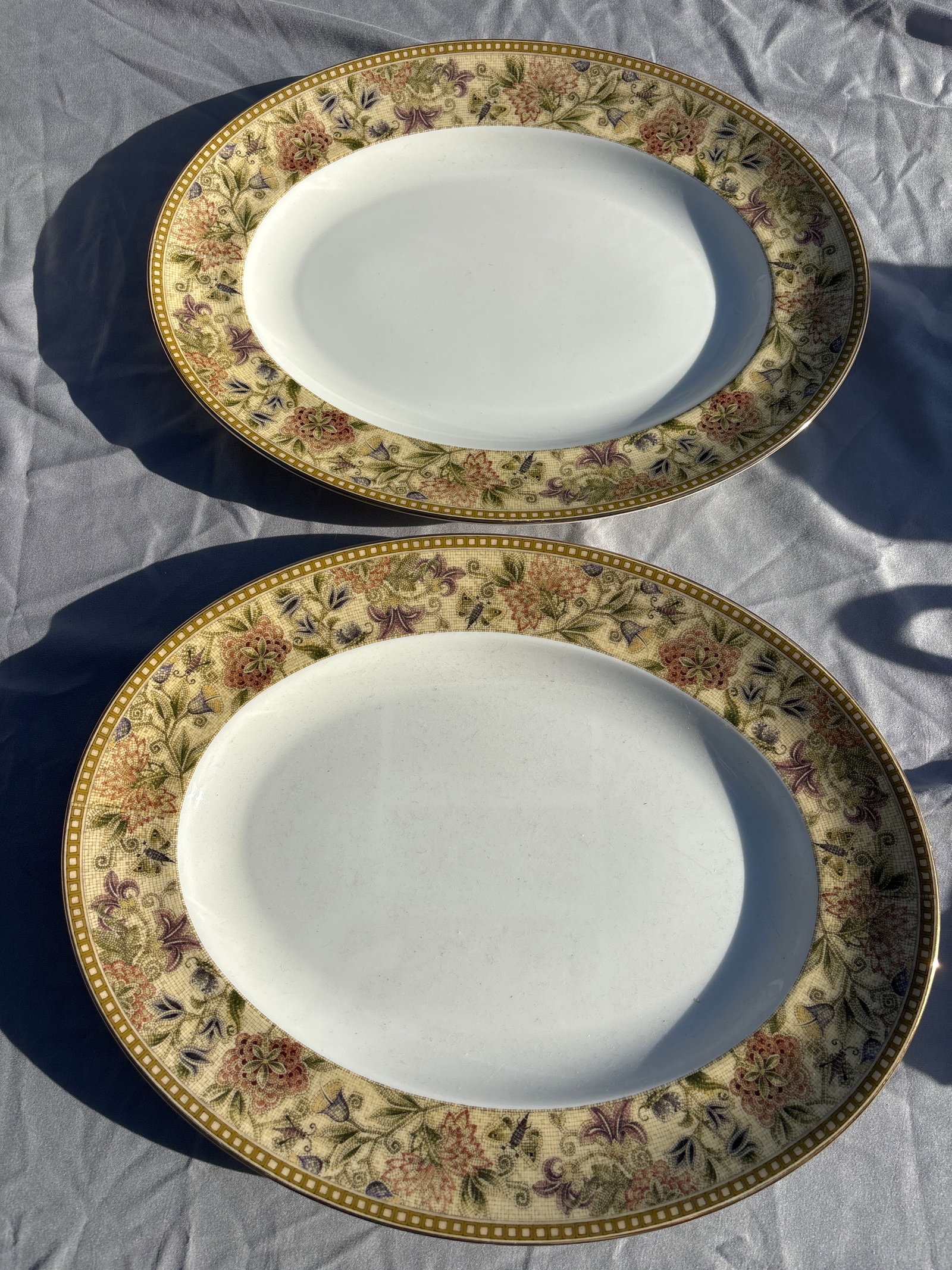 Two Wedgwood Floral Tapestry 14 inch serving platters: Wedgwood Floral Tapestry 14 inch serving platters crafted from fine bone china in England.Pattern Details: Features a textured olive and sage green border with multicolored floral sprays, subtle bee m