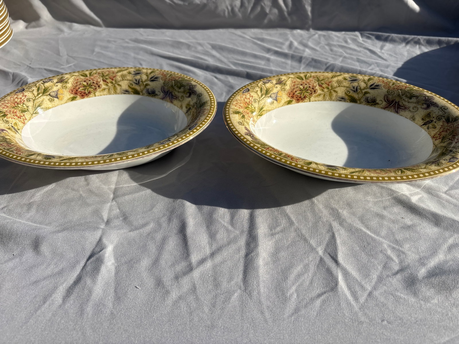 Two Wedgwood Floral Tapestry 9&3/4 inch veggie serving bowls: Wedgwood Floral Tapestry 9&3/4 inch veggie serving bowls crafted from fine bone china in England.Pattern Details: Features a textured olive and sage green border with multicolored floral sprays, subtl