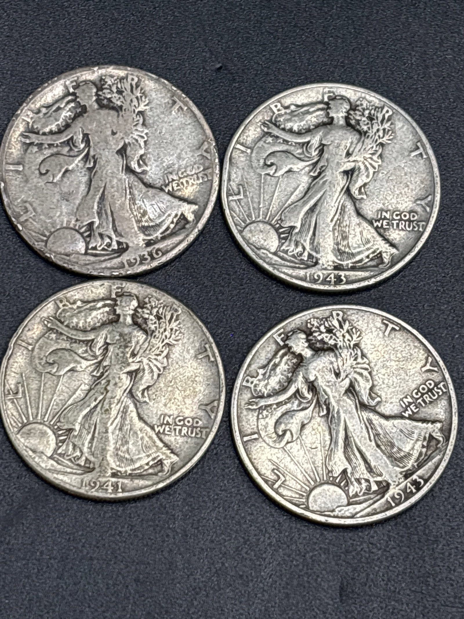 Four pre WWII silver Walking Liberty Half Dollars: Four pre WWII silver Walking Liberty Half Dollars, a 90% silver U.S. coin designed by Adolph A. Weinman featuring Lady Liberty striding toward the dawn. In its current circulated condition, it is gene