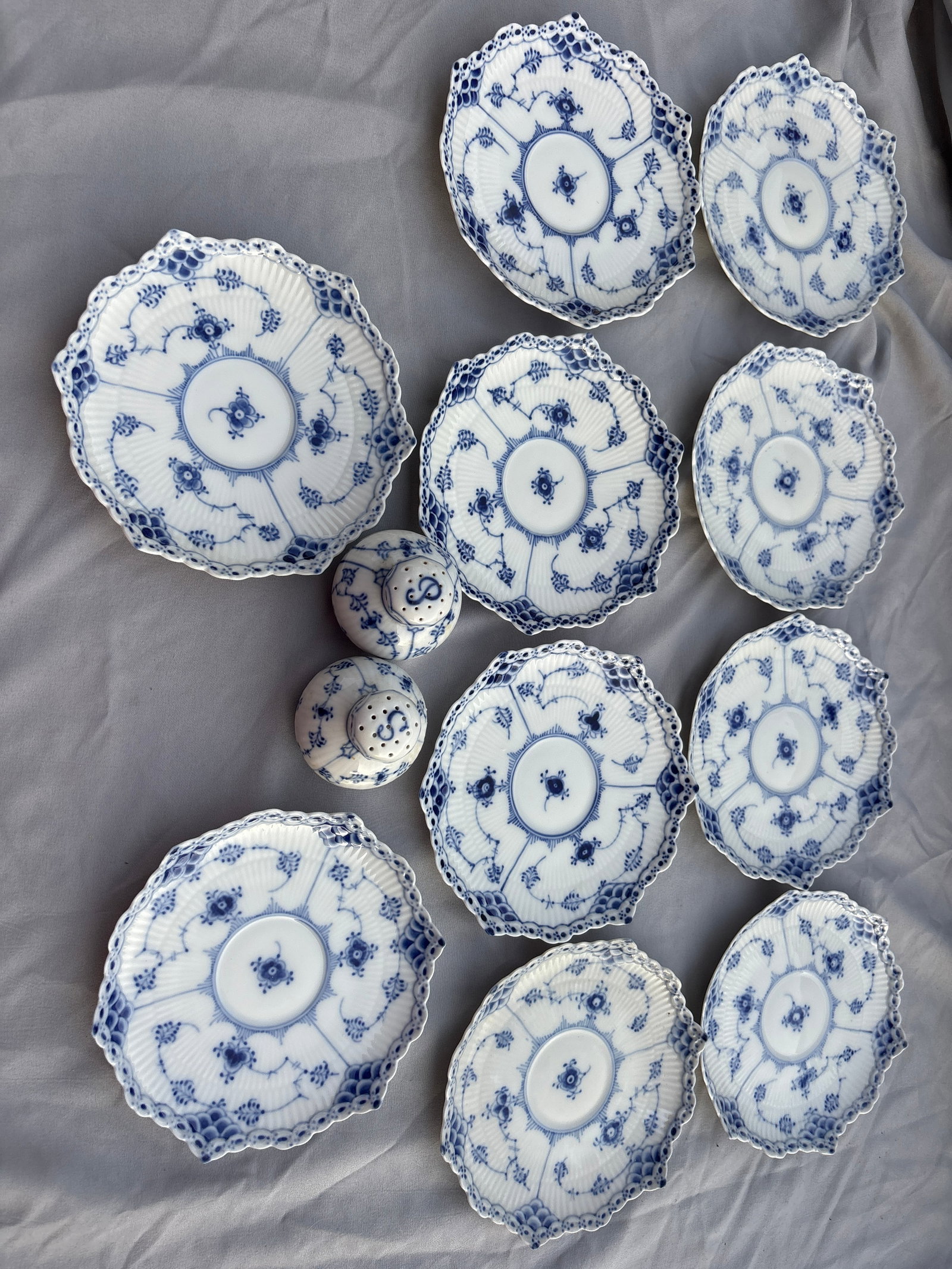 Pair shakers & ten 5&3/4 inch Royal Copenhagen Blue Fluted Full Lace porcelain: Royal Copenhagen Blue Fluted Full Lace porcelain piece (often produced as a shallow bowl, cake plate, or saucer like model #1018 or #1062), featuring hand-painted blue floral motifs and an open-work