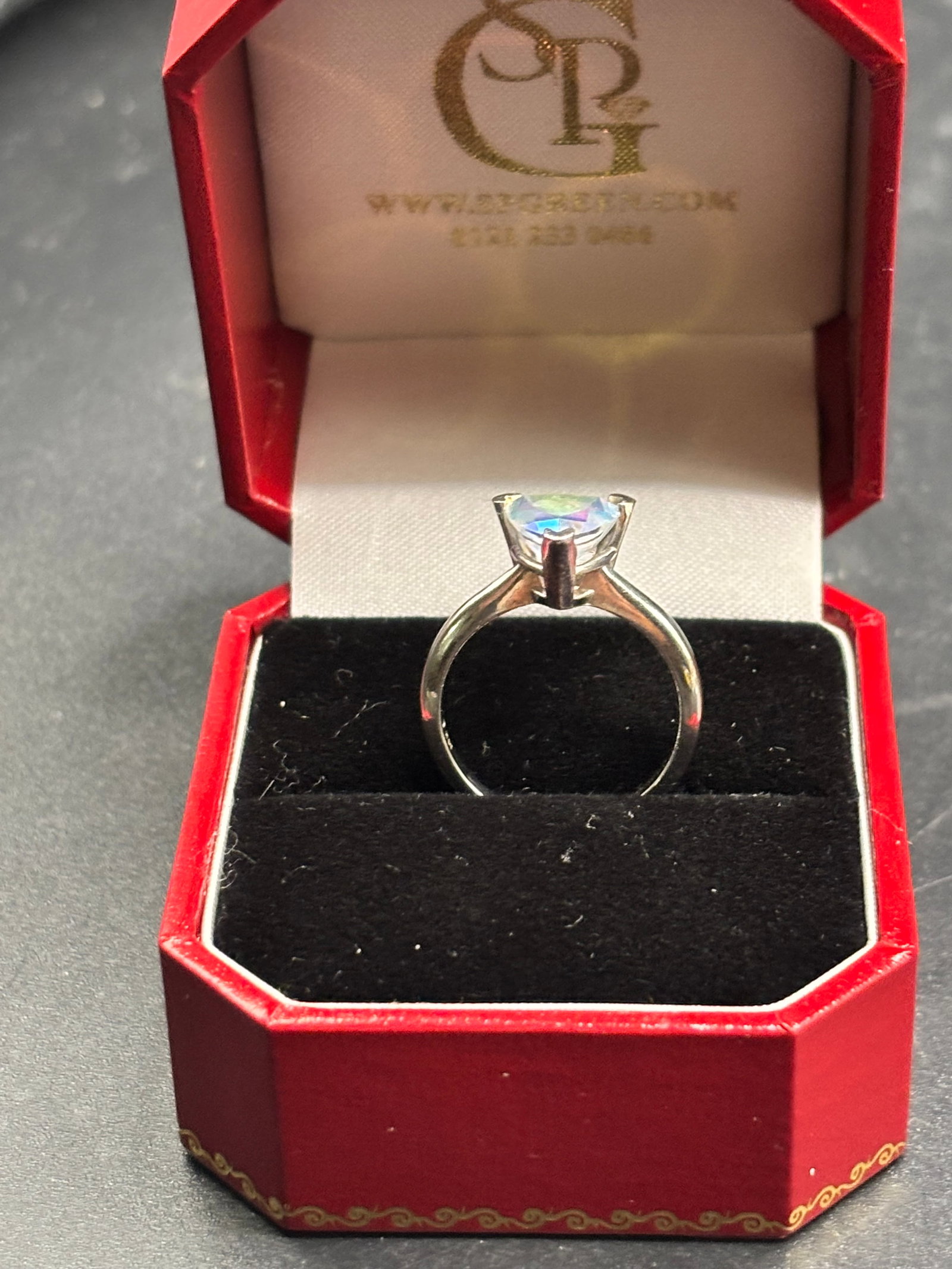 3.46 grams 14 k yellow gold trillion cut gemstone crystal ring: Swarovski…14k white gold solitaire ring featuring a triangular (trillion-cut) gemstone with strong iridescent flashes.Gemstone PossibilitiesGiven its colorful, multi-toned optical properties, the st