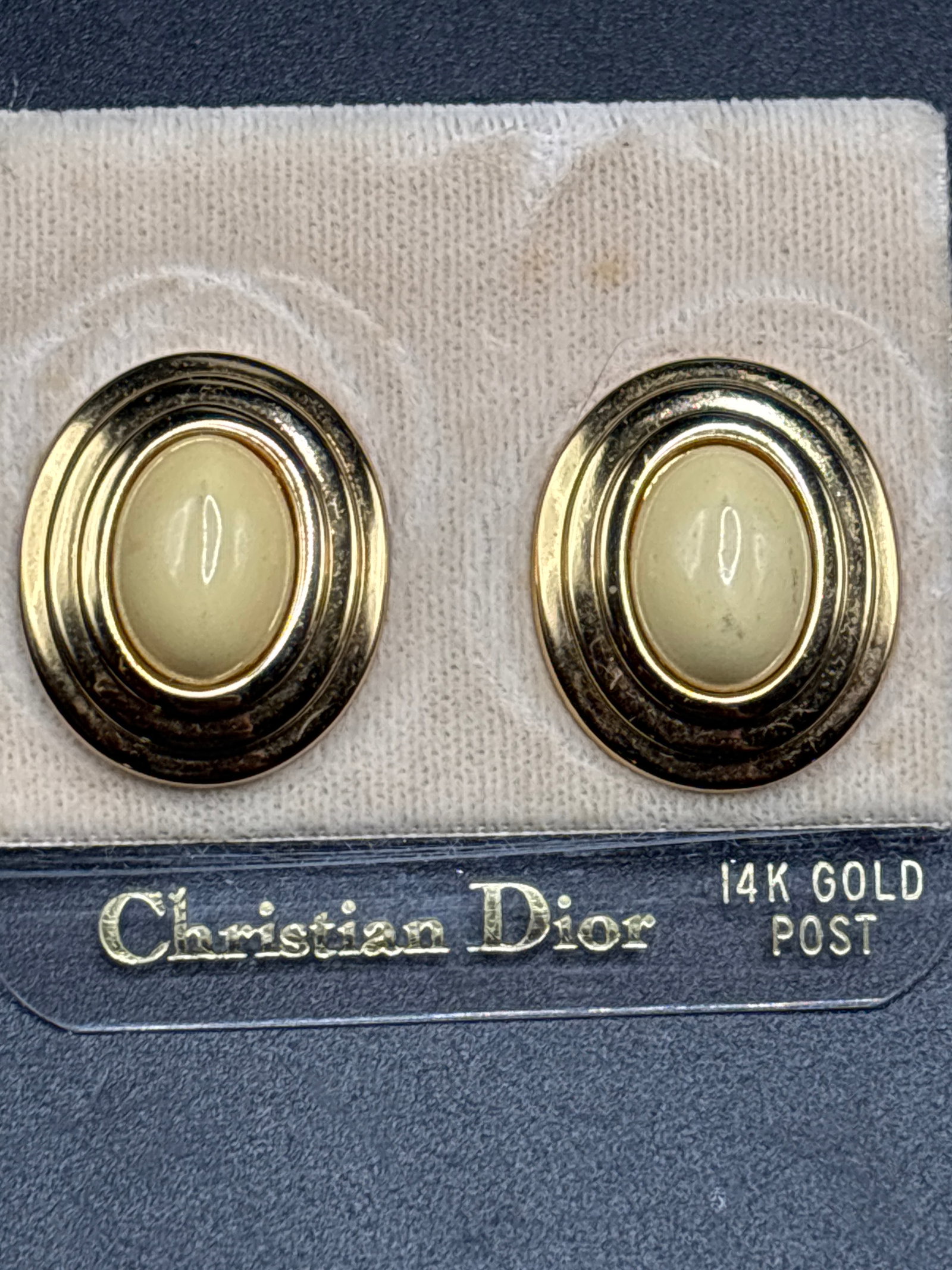 14 k gold posts pair of vintage Christian Dior oval stud earrings: pair of vintage Christian Dior oval stud earrings featuring smooth, creamy off-white cabochons.Product BreakdownBrand: Christian DiorDesign: Smooth oval cream/ivory lucite or glass centers surrounded 