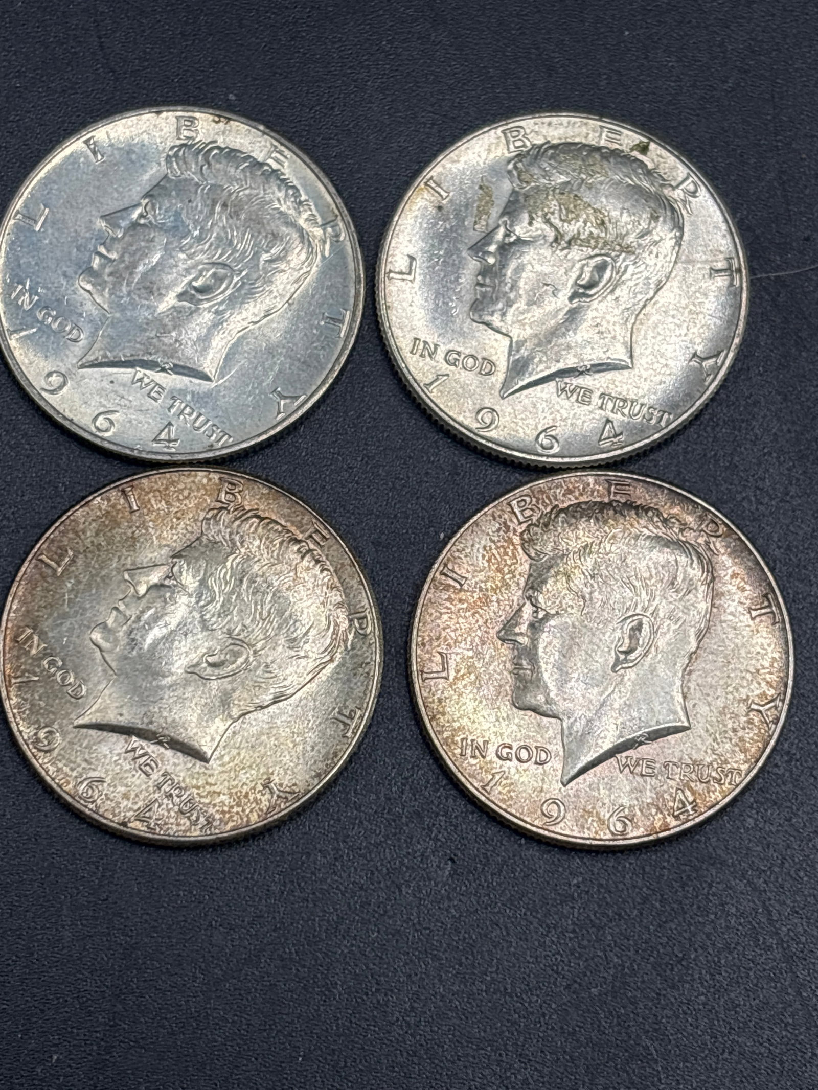 four silver 1964 United States Kennedy half dollars: four 1964 United States Kennedy half dollars, which are notable for being composed of 90% silver (the final year the US Mint used 90% silver for circulation half dollars before reducing it to 40% and 