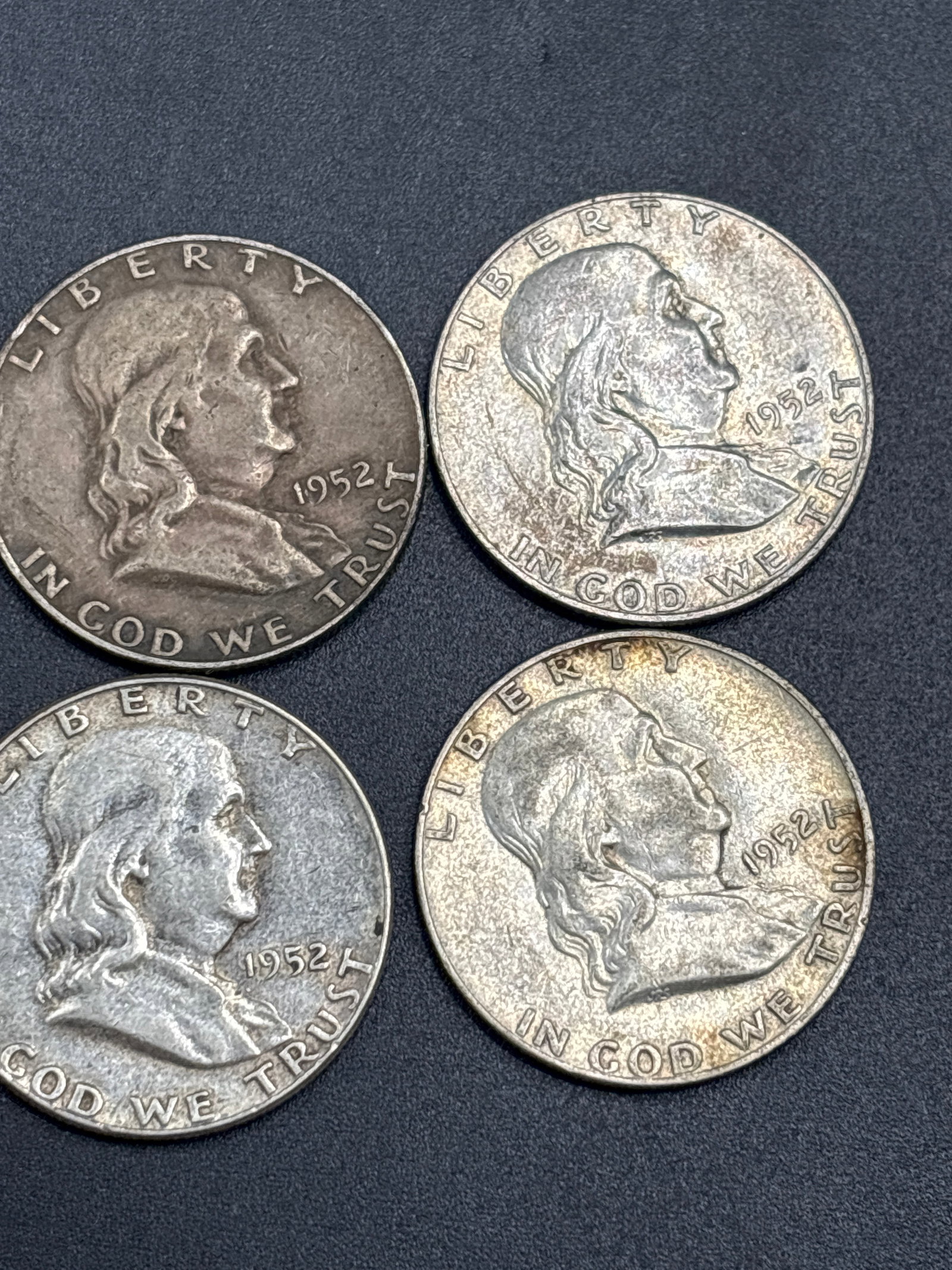 Four silver 1952 United States Franklin half dollar: Four 1952 United States Franklin half dollar, composed of 90% silver with a denomination of 50 cents. It features the profile of Benjamin Franklin on the obverse and was designed by John R. Sinnock.Co