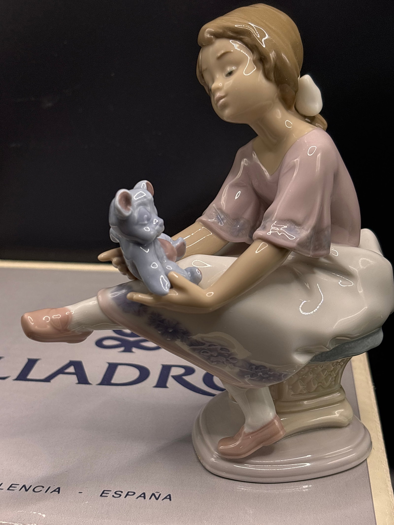 Lladró porcelain 6.25 inch figurine Best Friend Figurine #7620: With box, retired Lladró "Best Friend" Figurine #7620, a glossy porcelain piece featuring a young girl in a pastel pink top and white skirt holding a light blue teddy bear.Sculptor: Francisco PolopeR