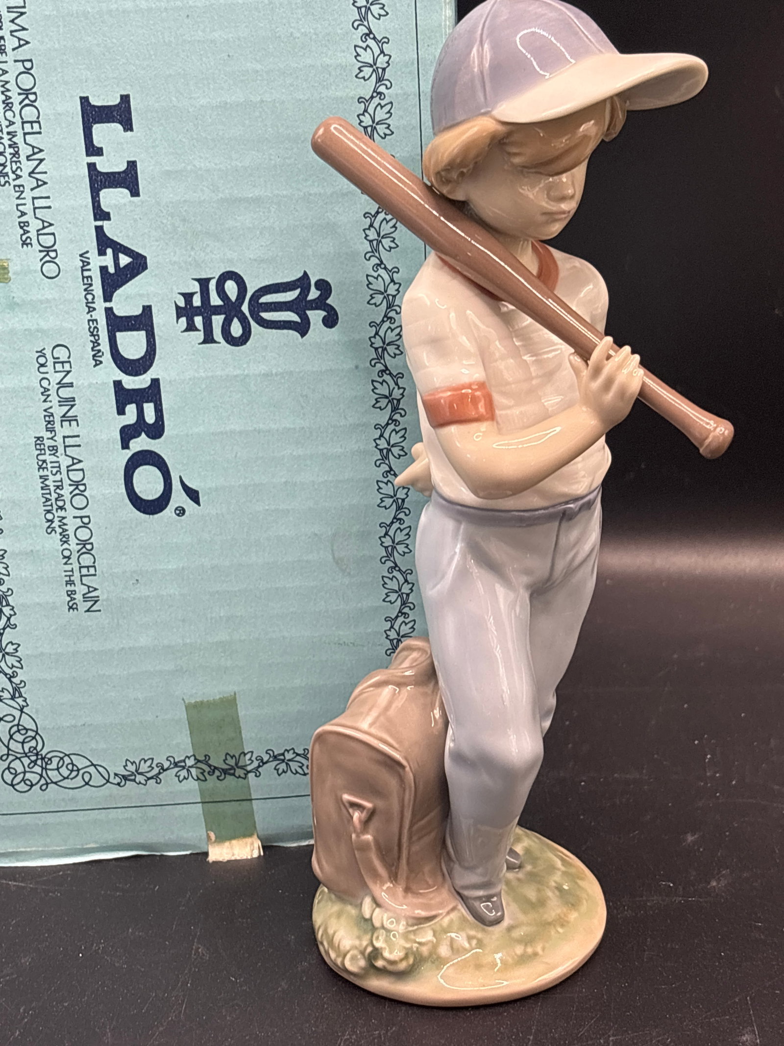 Lladró porcelain 6.25 inch figurine Can I Play Figurine #7610: With box, Lladró "Can I Play?" porcelain figurine (Model #7610) is a retired 1990 Collector's Society piece depicting a young boy in a baseball cap holding a bat next to his gear.Artist/Sculptor: Fra