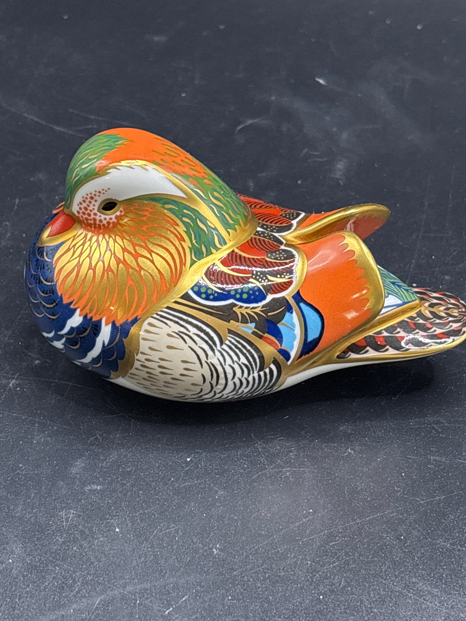 Royal Crown Derby Mandarin Duck fine bone china paperweight 4 inch figurine: Silver stopper, no box. Royal Crown Derby Mandarin Duck fine bone china paperweight figurine. Royal Crown Derby, a famous porcelain maker in England.Design: A colorful Mandarin Duck featuring vibrant 