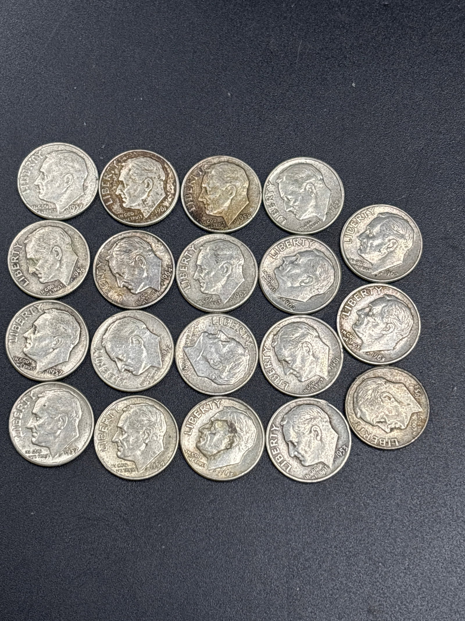 Ninteen assorted silver United States Roosevelt dimes: Ninteen United States Roosevelt dimes arranged in a grid.Coin DetailsType: Roosevelt DimeObverse Design: Features the profile of President Franklin D. Roosevelt with the text "LIBERTY" and "IN GOD WE 