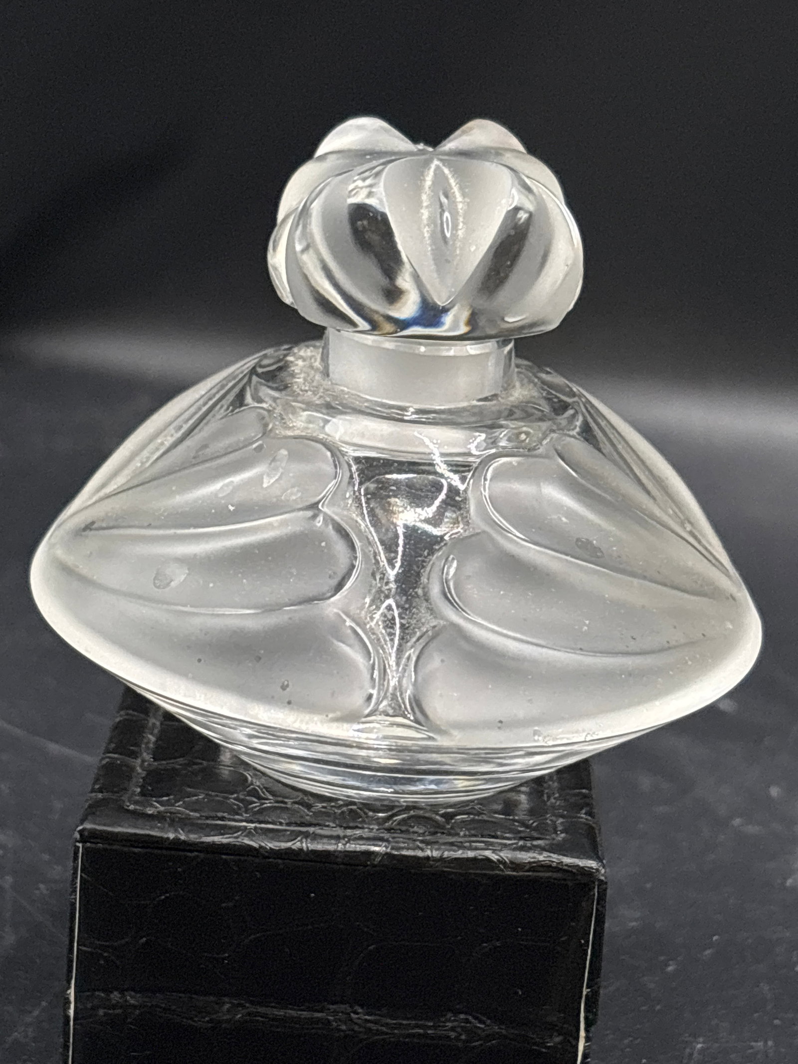 vintage Lalique "Thais" Crystal 4 inch Perfume Bottle: This exquisite frosted art glass piece is a vintage Lalique "Thais" Crystal Perfume Bottle.Designed by Marie-Claude Lalique in 1979, it features a signature blend of satin-frosted and clear lead cryst