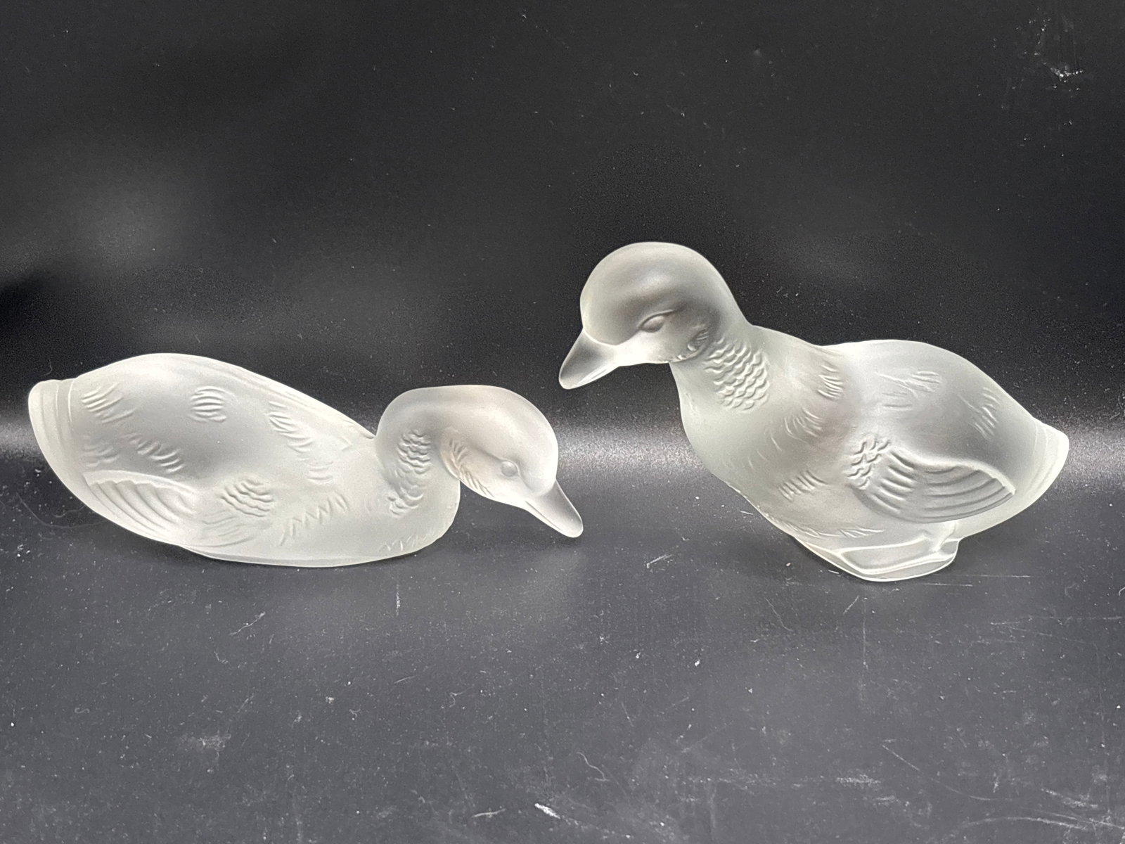 pair of vintage Baccarat Frosted Crystal Duck Figurines: pair of vintage Baccarat Frosted Crystal Duck Figurines crafted in France.DetailsMaterial: Frosted (satin finish) lead crystalDesign: Two stylized resting and swimming ducks with molded feather detail