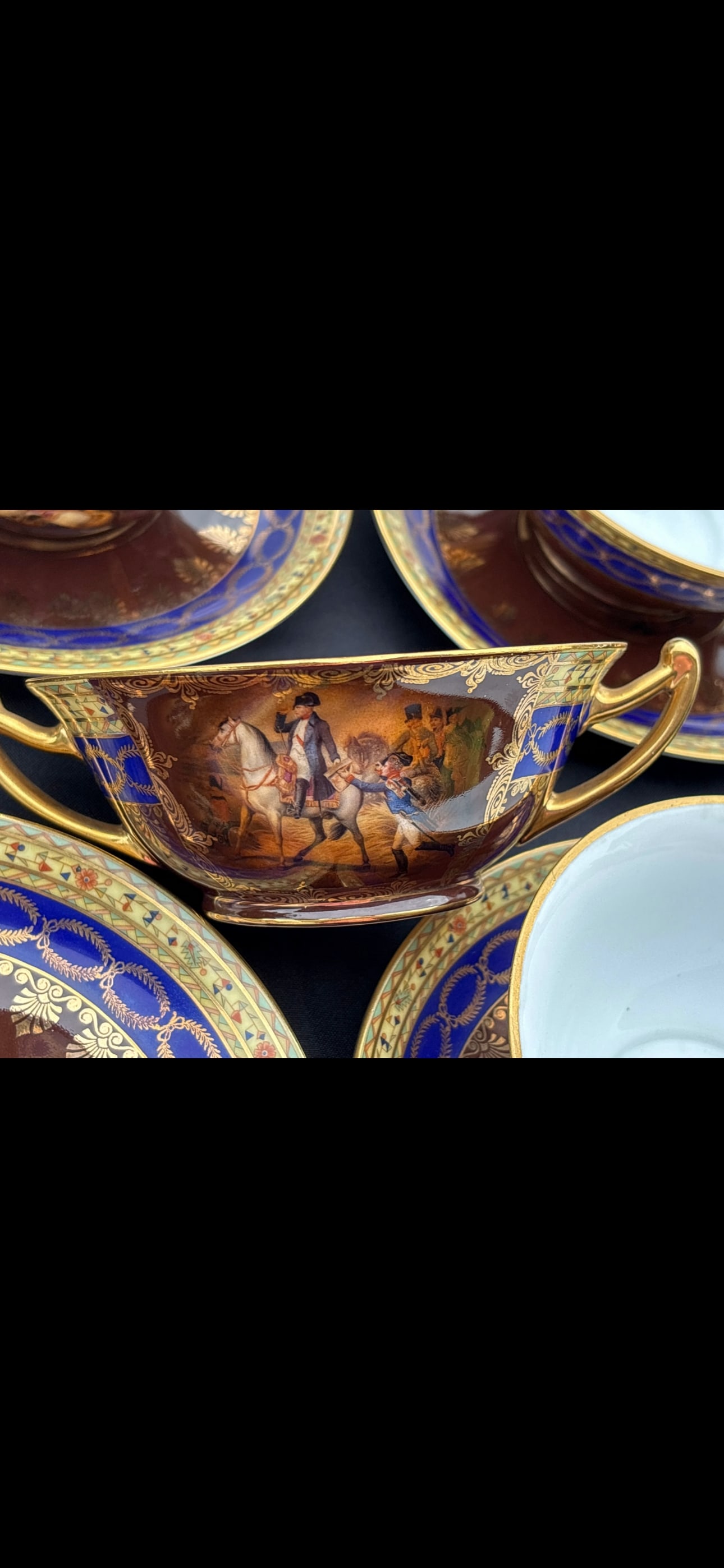 Fourteen piece Napoleonic antique porcelain double handle cups/bowls: antique porcelain service appears to be a Carlsbad Royal Vienna set, likely produced in the early 20th century. These sets are characterized by their deep burgundy or "Rouge Royale" finish, heavy gold