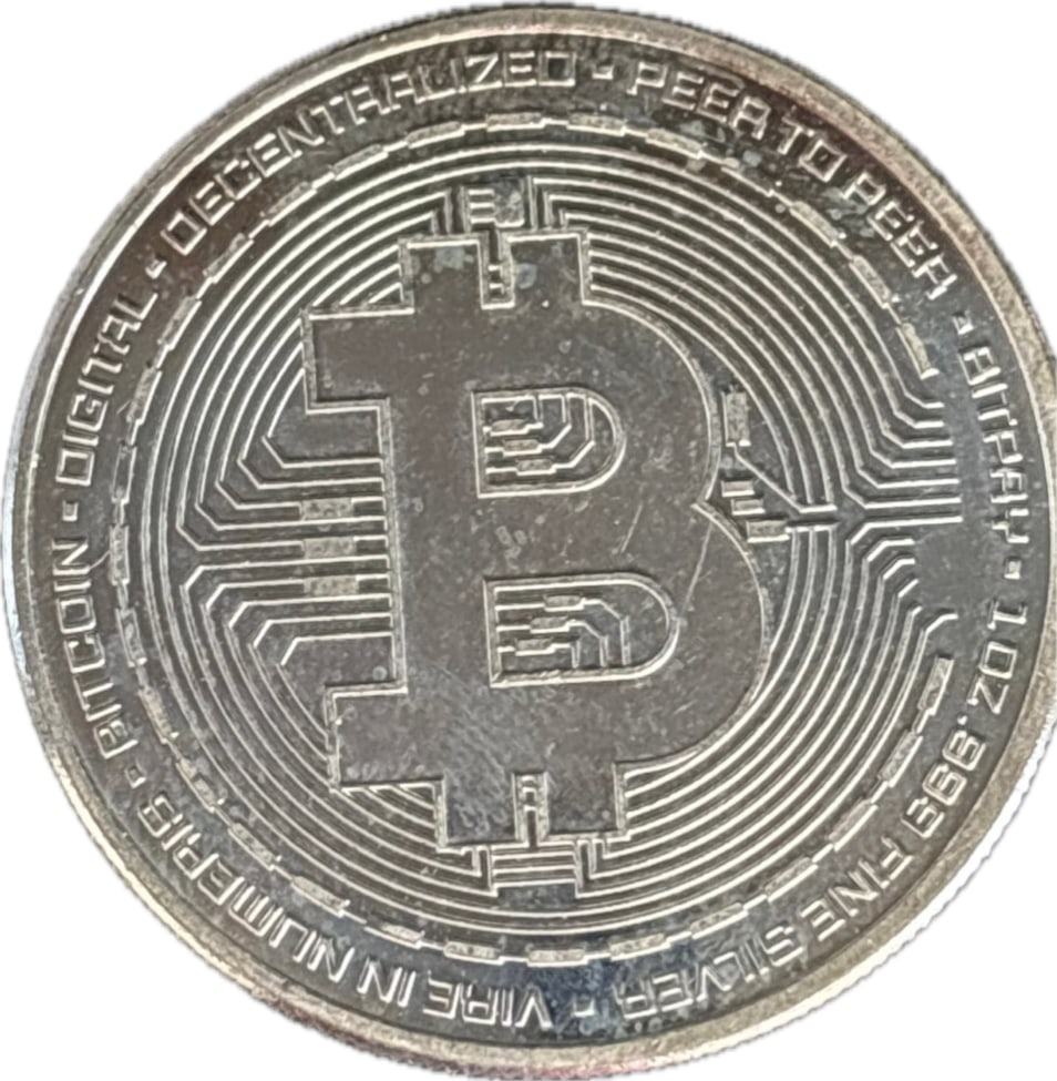 One troy ounce .999 fine silver Bitcoin physical commemorative coin: One troy ounce .999 silver; a physical commemorative coin designed to represent Bitcoin, commonly marketed as a collectible token rather than legal tender. Material: with higher-end versions are made 