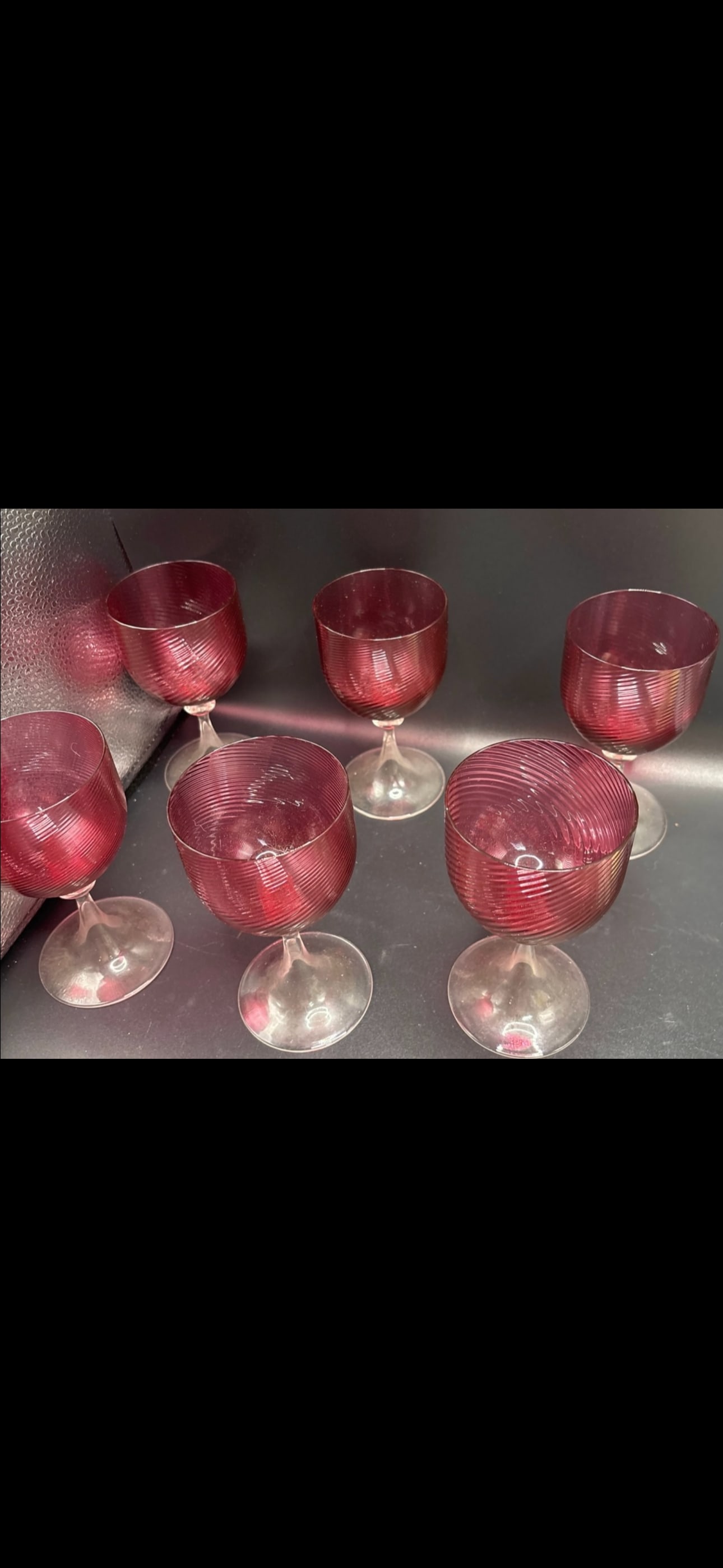Set of six unsigned Nason Moretti Murano cranberry glass 5&1/4inch glasses: Set of six unsigned Nason Moretti Murano cranberry glass goblets, specifically the "Twisted Ruby" model.The glasses feature a distinct twisted texture on the red bowl and a transparent stem and base.I