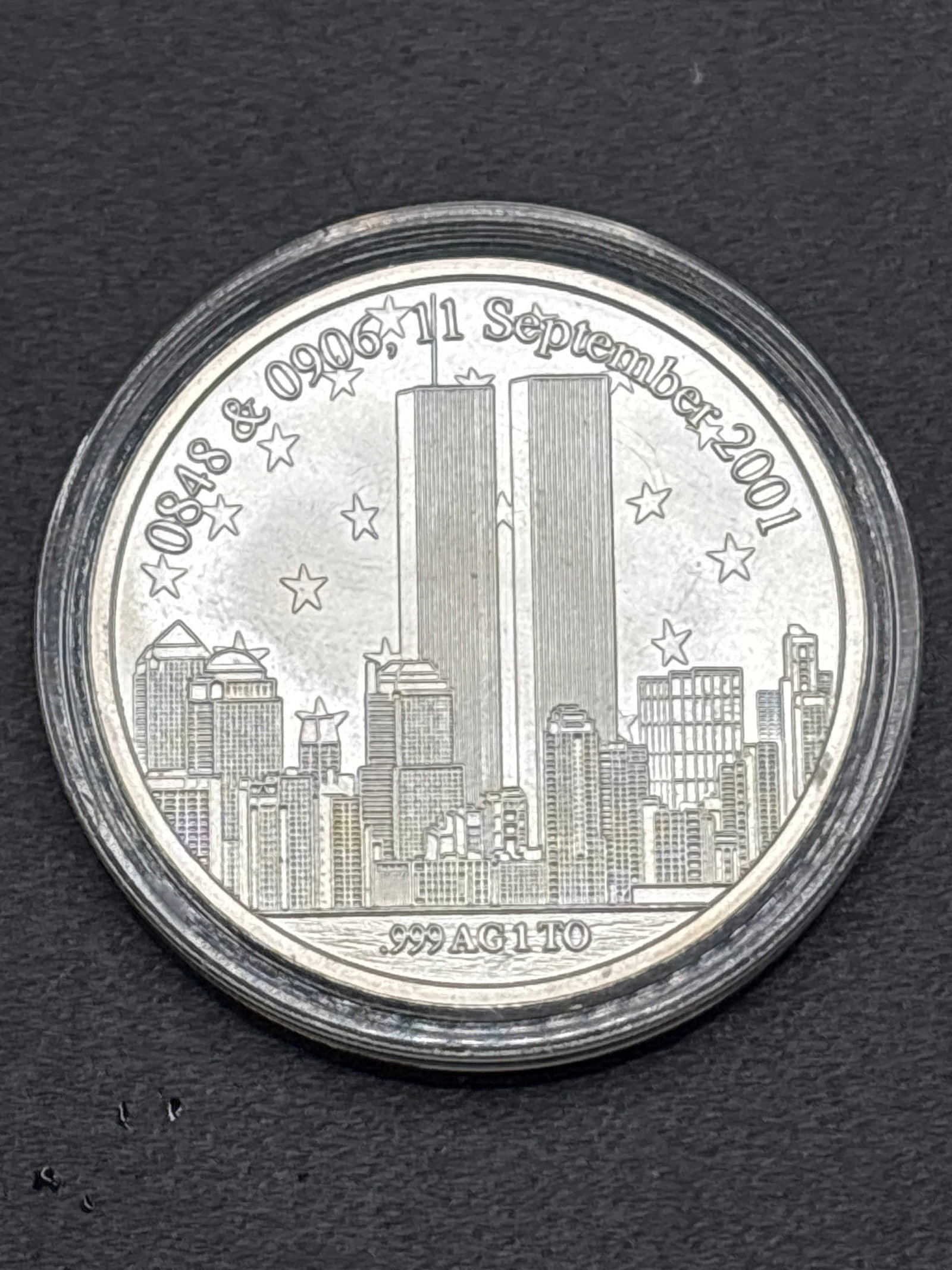 1-ounce .999 fine silver commemorative round dedicated to September 11, 2001: 1-ounce .999 fine silver commemorative round dedicated to the events of September 11, 2001. [1]Key Features* Design: The front shows an engraving of the World Trade Center twin towers and the New York