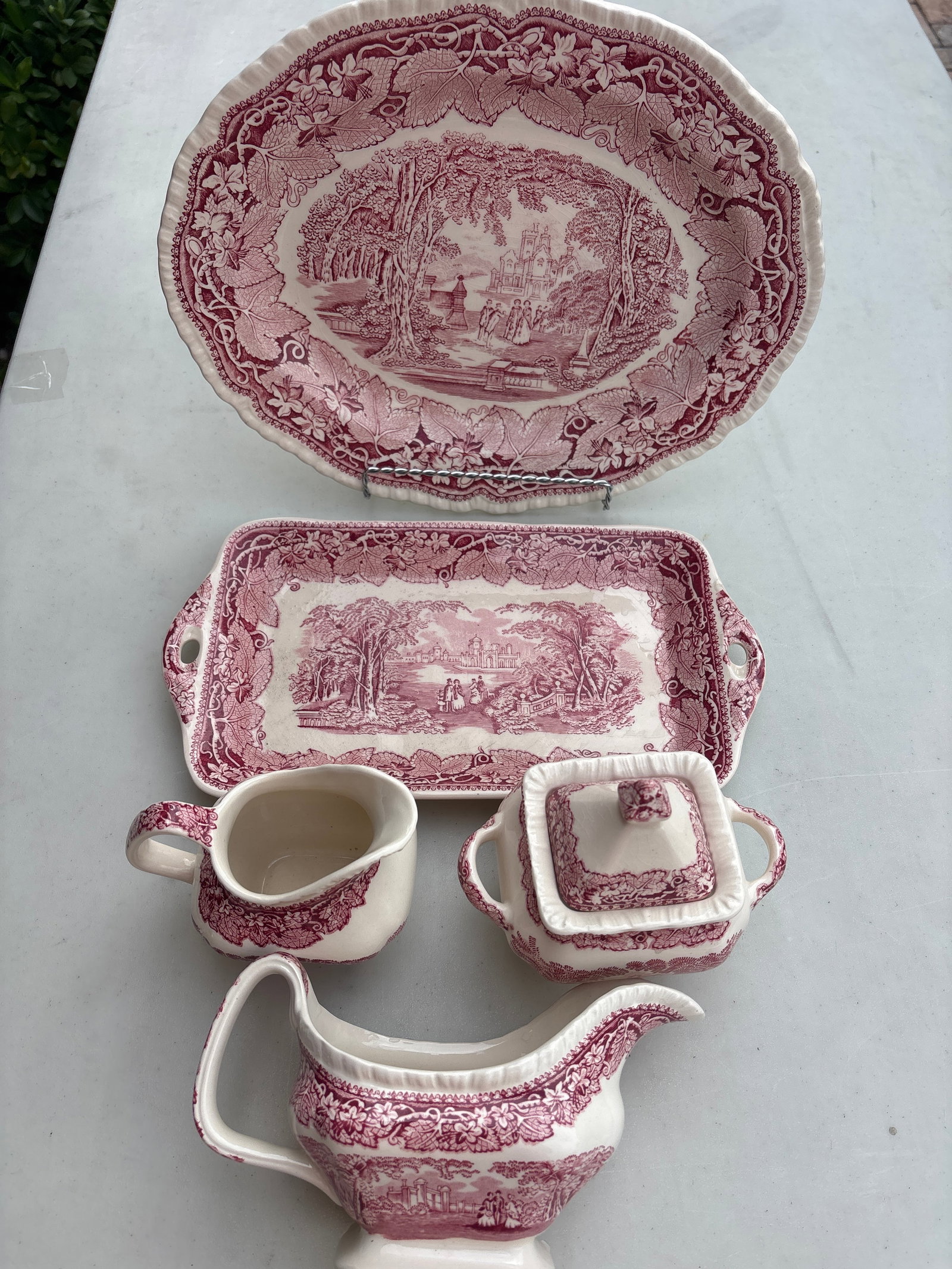 Five piece iconic Franciscan "Pink Vista" pattern: Five piece iconic Franciscan "Pink Vista" pattern in pink/red, highly recognizable by its romantic forest and castle landscape bordered by dense ivy leaves. [1, 2]While it is commonly associated with 
