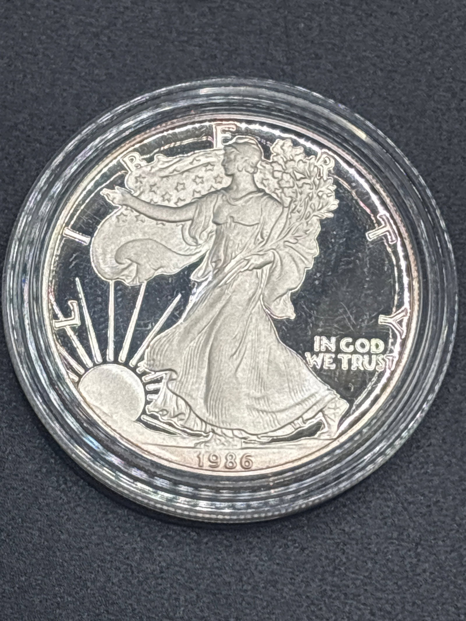 1 troy ounce 99.9% pure silver 1986 American Silver Eagle silver dollar coin: 1 oz American Silver Eagle silver dollar coin sealed inside a clear protective plastic capsule.Key Details* Design: Features the Walking Liberty walking toward the sun on the front, with the phrase "I