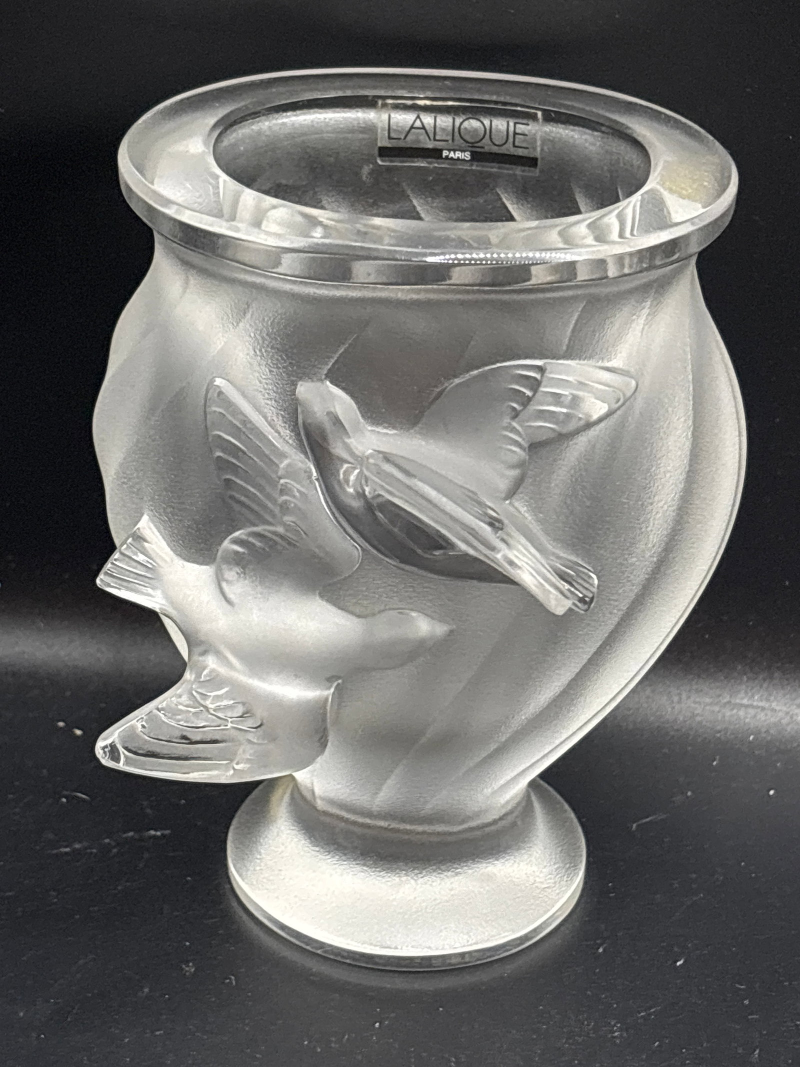 Authentic Lalique "Rosine" doves Vase, an iconic piece of French luxury crystalware: authentic Lalique France "Rosine" frosted crystal vase featuring a beautiful relief design of two flying doves. Designed with a classic satin-finished frosted texture contrasted by clear, flowing line
