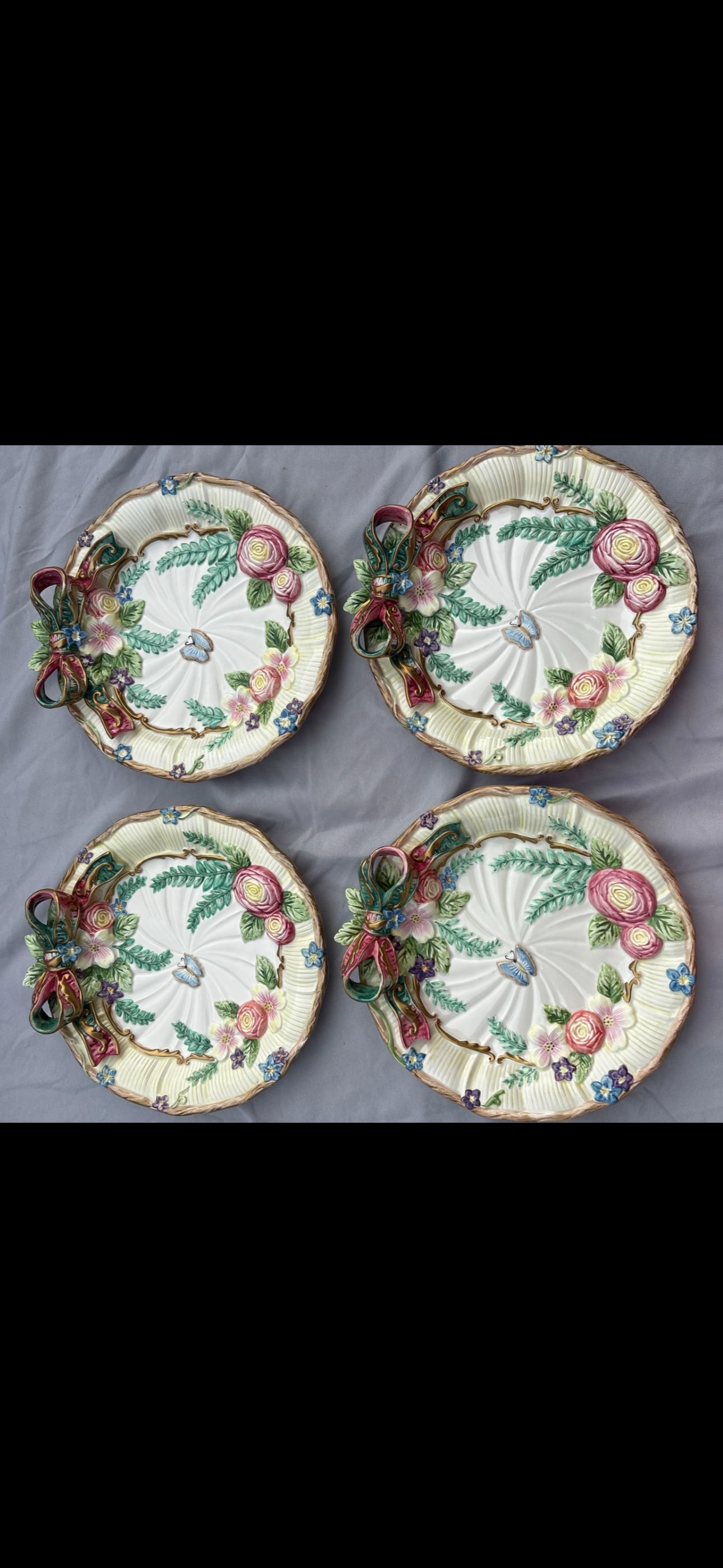 Four vintage Fitz and Floyd "Woodland Spring" decorative plates, 9&1/4 inch: Four vintage Fitz and Floyd "Woodland Spring" decorative plates features high-relief floral and butterfly motifs accented by a whimsical 3-dimensional ceramic ribbon bow. Originally released in the 19