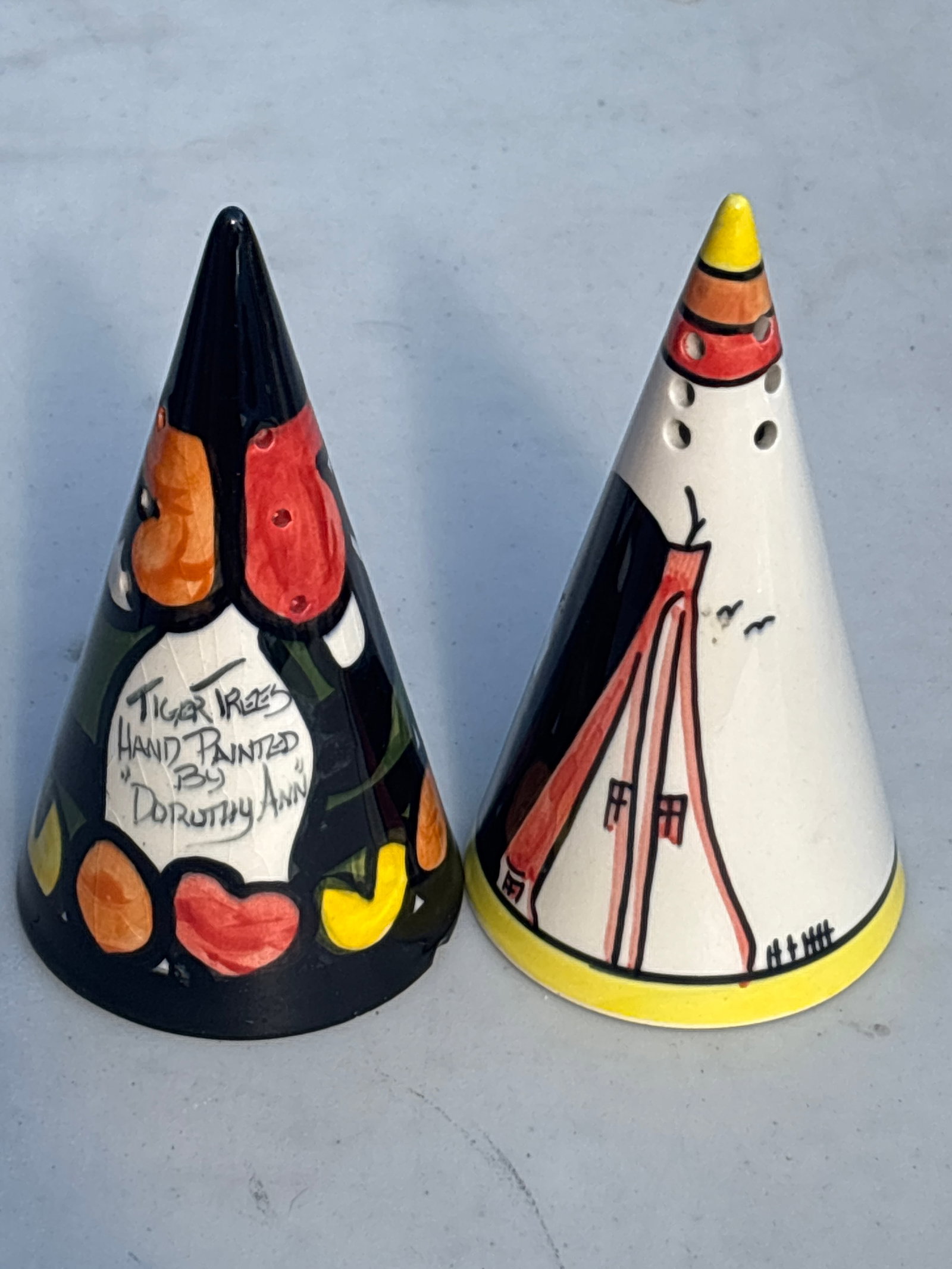 Two Crown Devon conical sugar sifters (shakers) "Tiger Trees" pattern: 5&1/2 inch Crown Devon conical sugar sifters (shakers) hand-painted by the ceramic artist Dorothy Ann in her highly collectible "Tiger Trees" pattern.The bold geometric design, vibrant stylized trees,