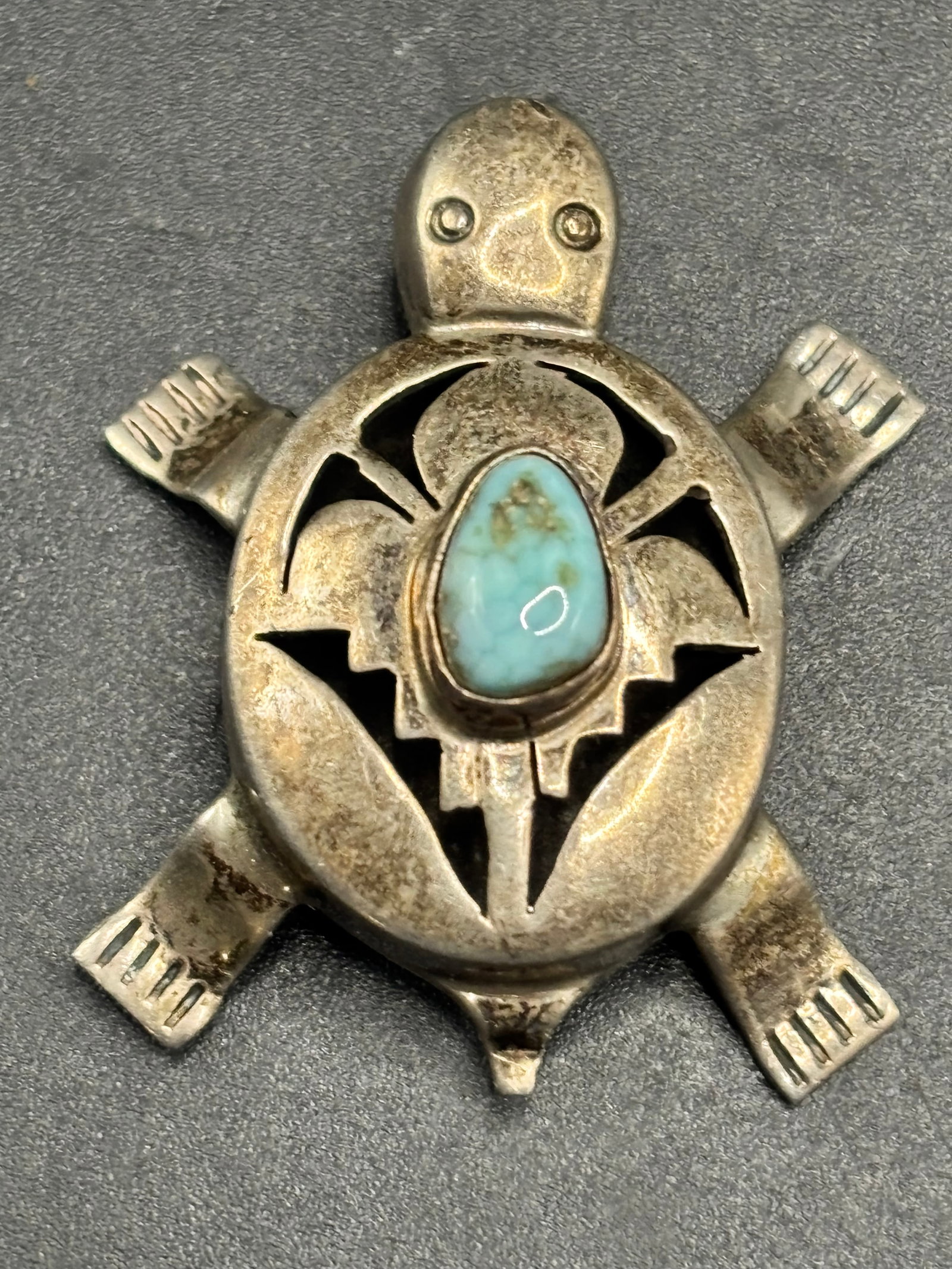 vintage sterling Bennie Ration Navajo shadowbox turtle brooch/pendant: Sterling 15.7 gramsThis beautiful piece is a vintage Navajo shadowbox turtle brooch/pendant handcrafted by the renowned Native American silversmith Bennie Ration. The piece features a distinctive thre