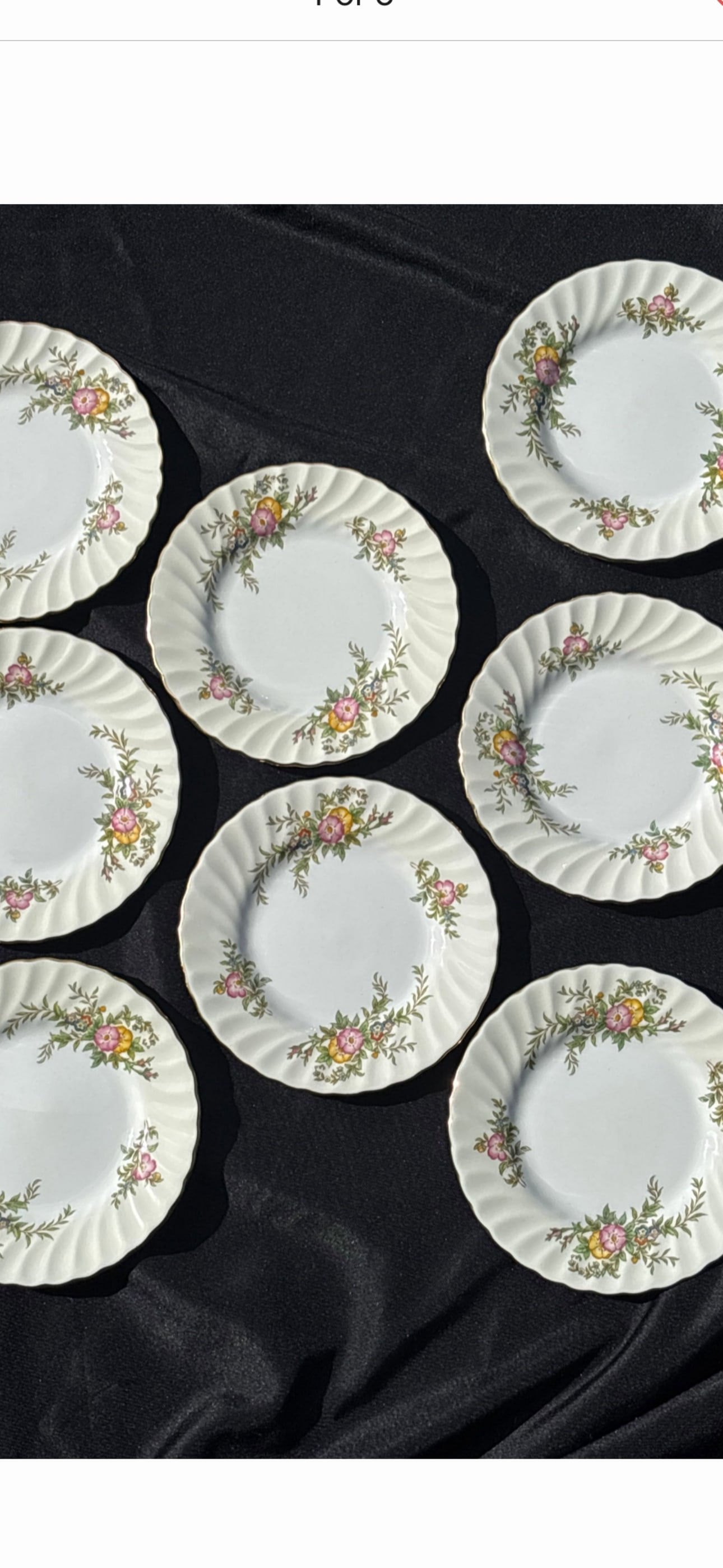 set of eight York vintage Minton bone china dinner 6&1/4 inch side plates: vintage Minton bone china dinner 6&1/4 inch side plates in the "York" pattern (number S501), manufactured in England between 1941 and 1969. Design: Features a swirled rim with pink and yellow floral s