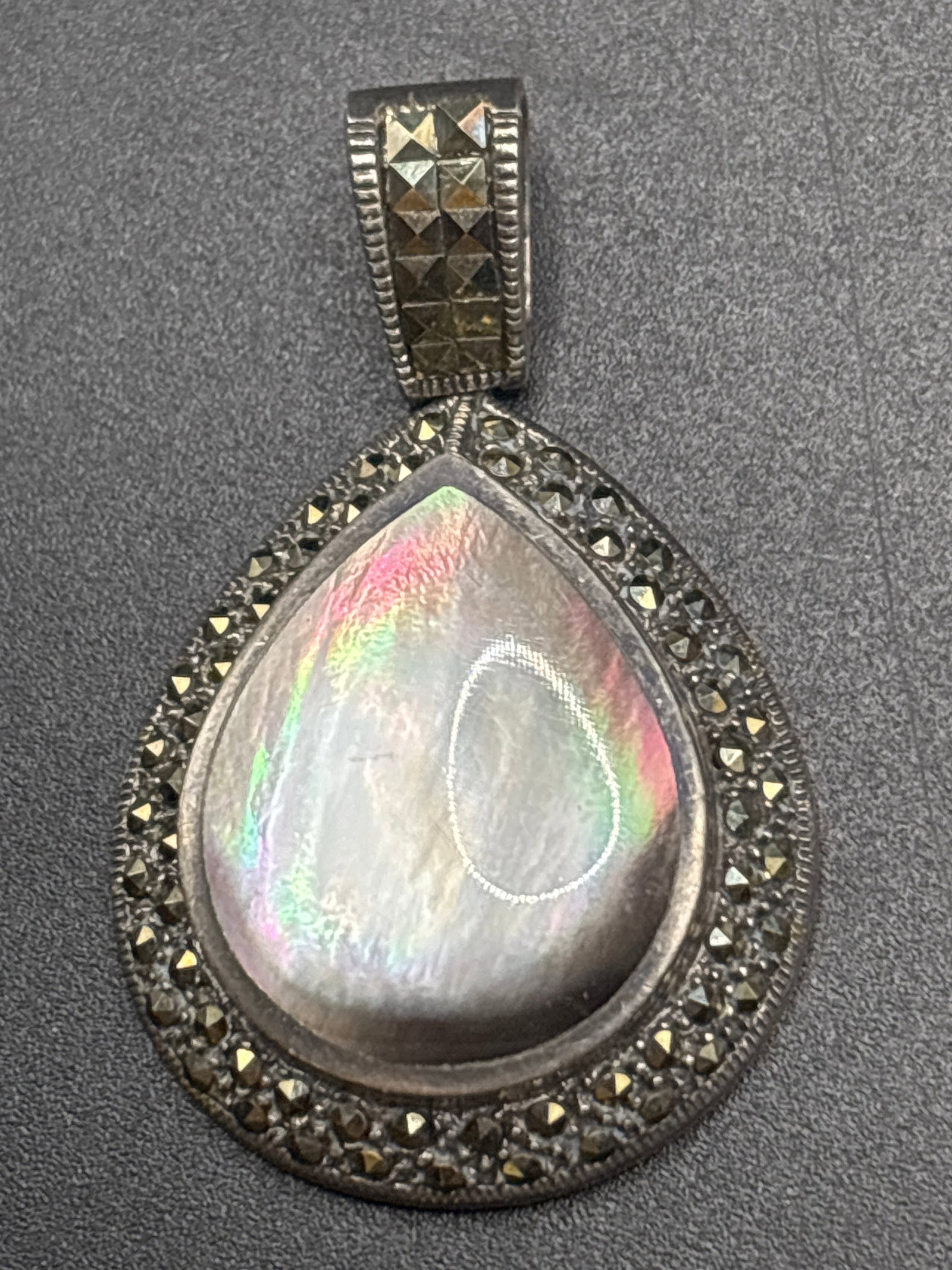Sterling Art Deco-style abalone & marcasite teardrop 1&1/2 inch pendant: Art Deco-style teardrop pendant featuring a luminous abalone mother-of-pearl cabochon framed by sparkling marcasite stones on a silver-tone setting