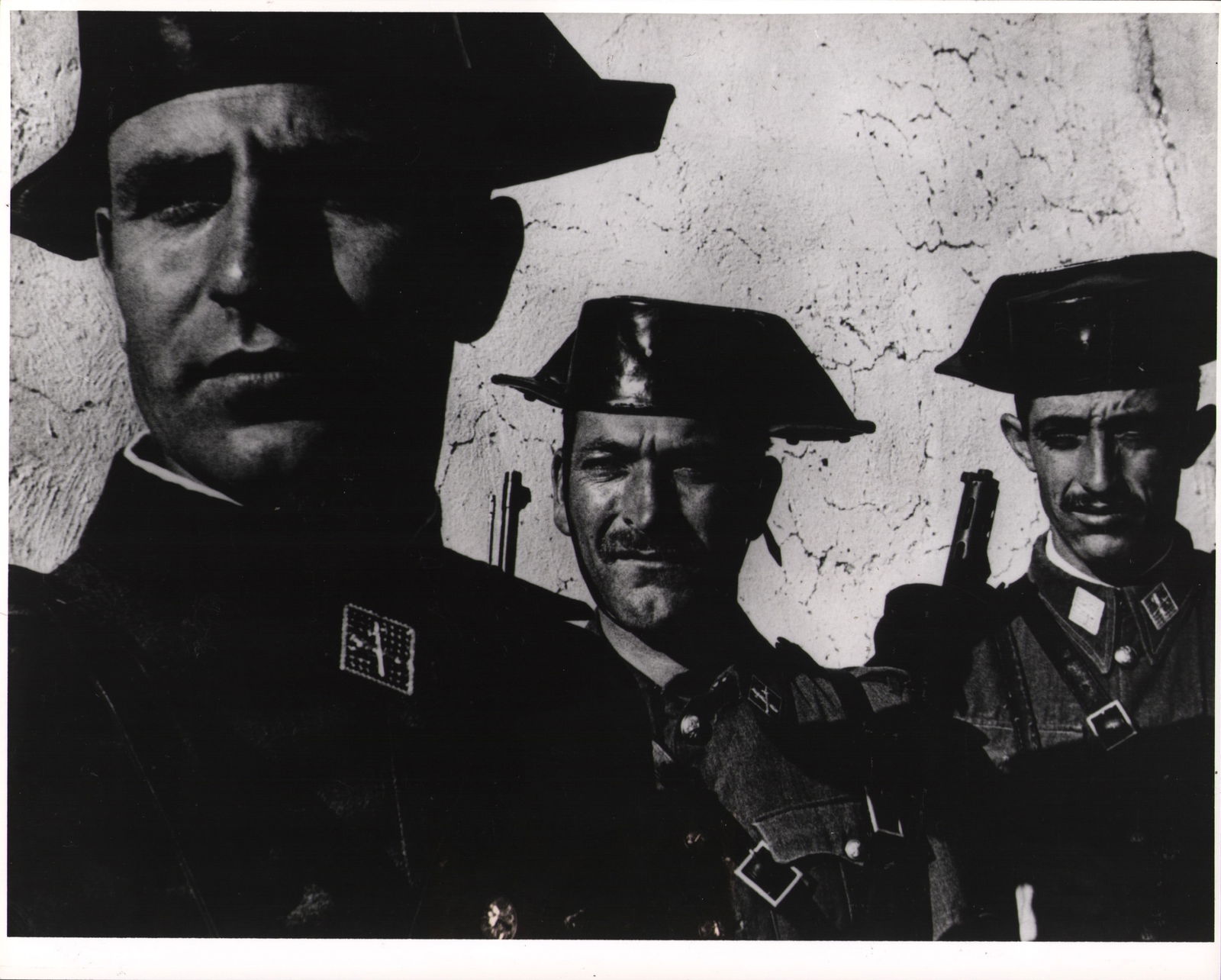 W. Eugene Smith (1918-1978), Guardia Civil, Spanish Village, 1951: W. Eugene Smith (1918-1978), Guardia Civil, Spanish Village, 1951, H x W: 25.3 x 20.3 cm, gelatin silver, features the Estate-stamp on verso.