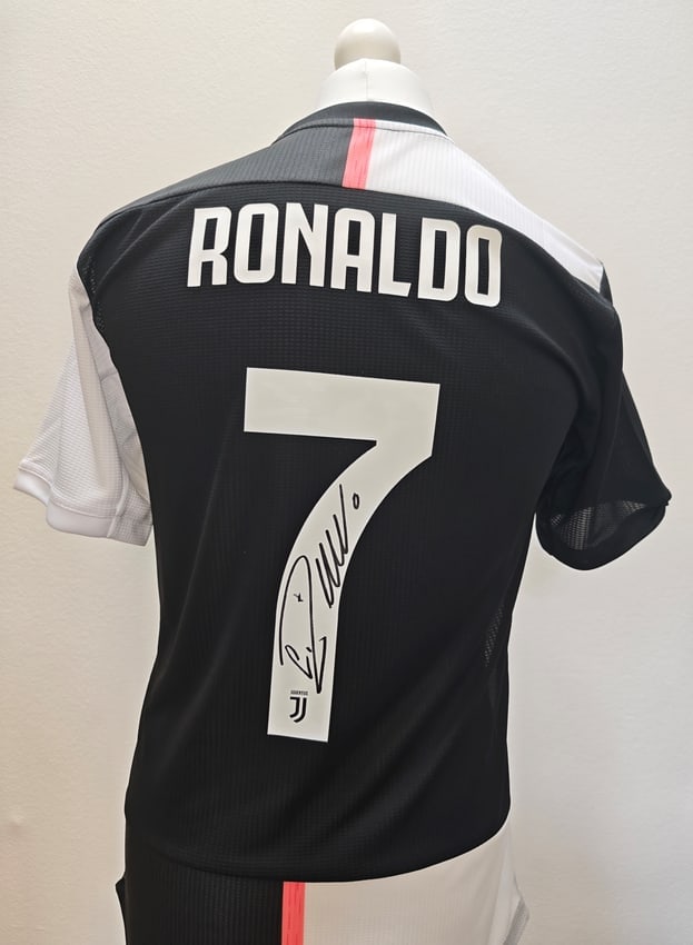 Cristiano Ronaldo Signed Juventus 2019-2020 Jersey #7 (ICONS Authenticated): Juventus home jersey, signed by Cristiano Ronaldo. The black shirt features his name and number 7 on the back, with the signature placed on the number. Included is an ICONS certificate of authenticity