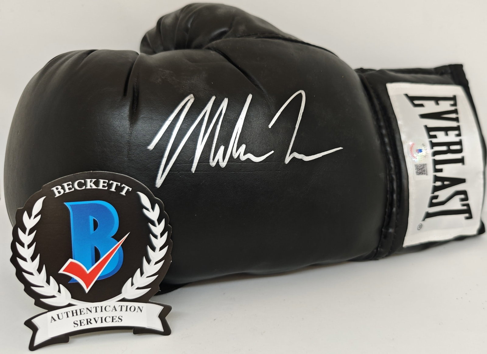 Mike Tyson Signed Boxing Glove, Beckett COA: Mike Tyson, "Signed boxing glove", a boxing glove signed by Mike Tyson in silver marker across the backhand. The glove bears a Beckett Authenticated hologram, no. B025666.