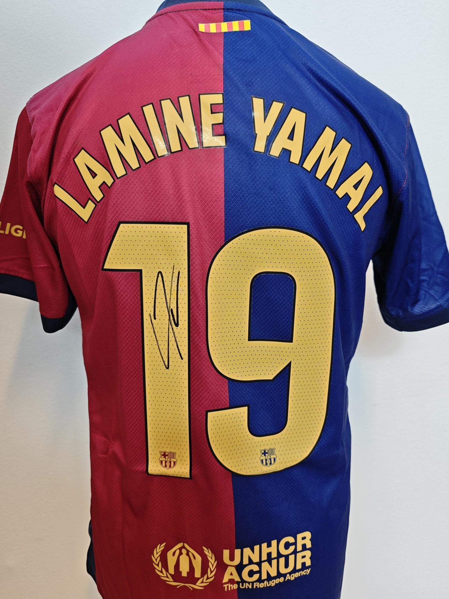 Yamal Signed Barcelona 24-25 Shirt #19, COA: Lamine Yamal, "FC Barcelona 2024-25 home shirt #19", a jersey. Signed in black marker above the #19 and authenticated by Exclusive Memorabilia (signed in Barcelona, November 2025), with hologram 24454