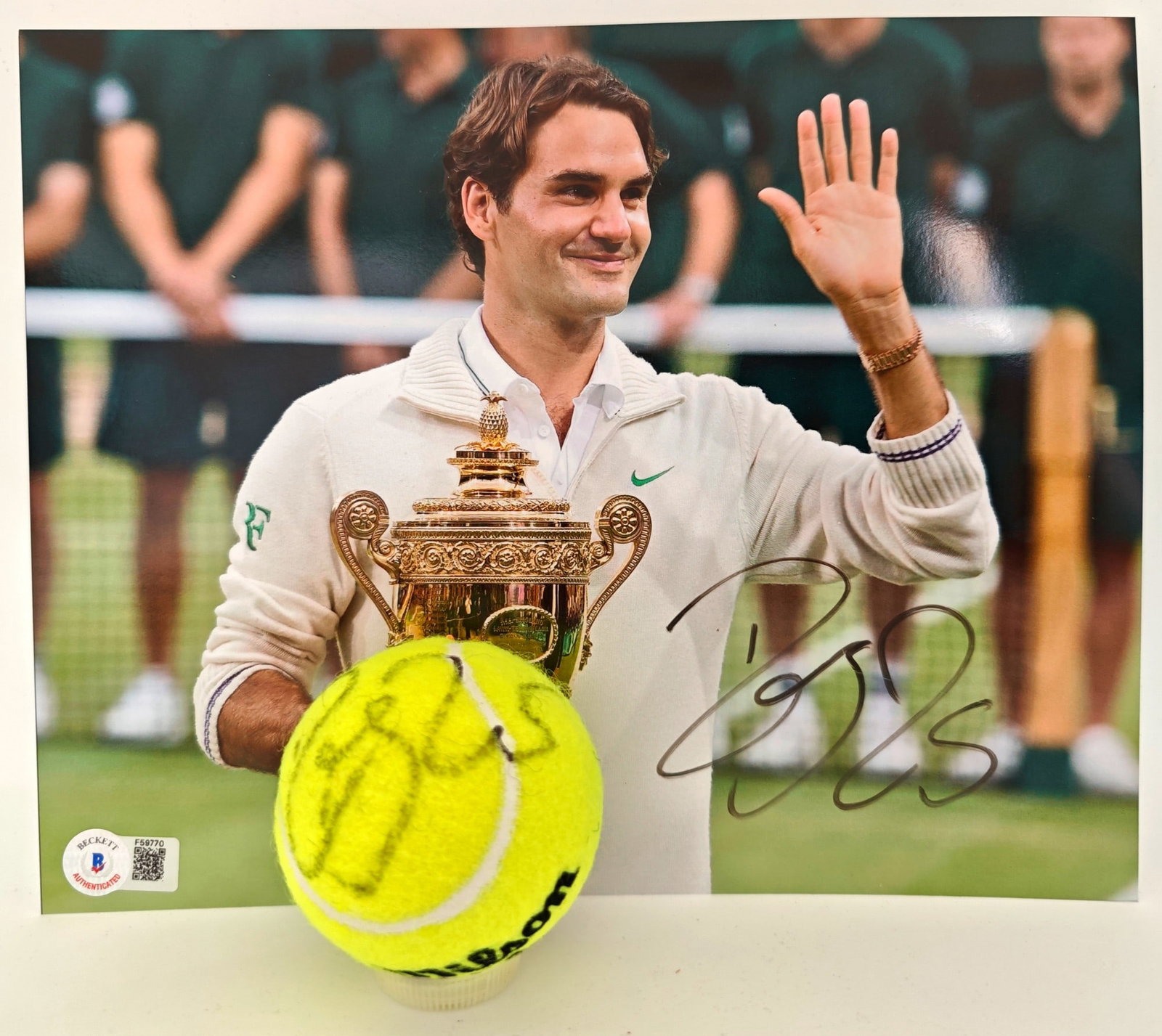 Federer Signed Poster & Ball, Beckett COA: Roger Federer, poster and tennis ball. The photograph is signed by Federer in black marker, Beckett authenticated (F59770), and accompanied by a signed tennis ball, also authenticated by Beckett.