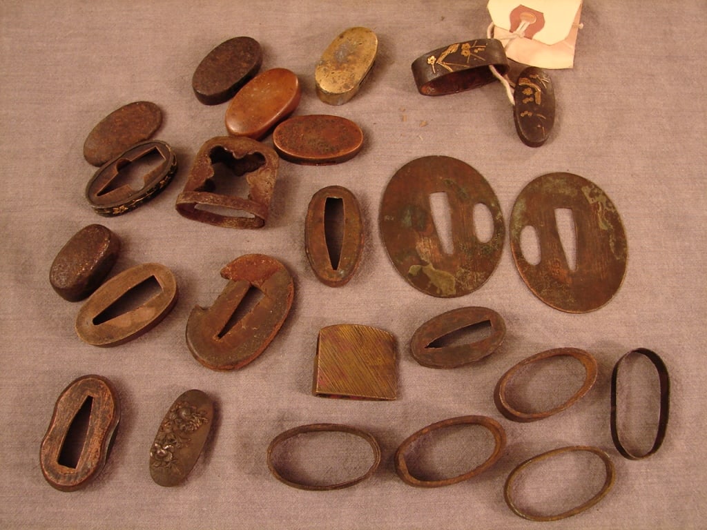 Japanese sword parts - fittings: Japanese sword parts - fittings. 24 total items in this lot. Various old Japanese swords fittings including saya throat, fuchi, kasjira, seppa, habaki. Various ages but all are edo period or older. On