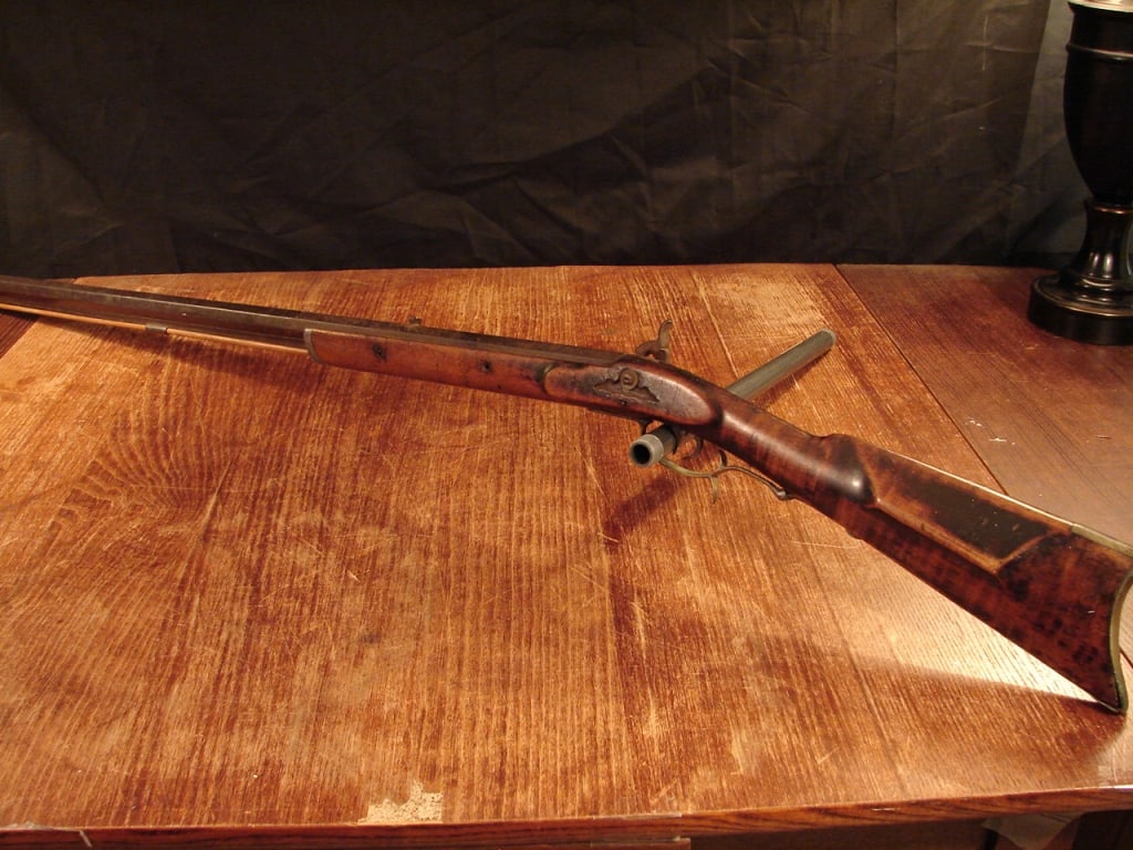 Percussion half stock frontier "plains Rifle": Percussion half stock frontier used "plains Rifle". Shows heavy use and patina with visible repairs. Has a number 14 in the bottom of the stock. An example of the guns that migrated west by early fron