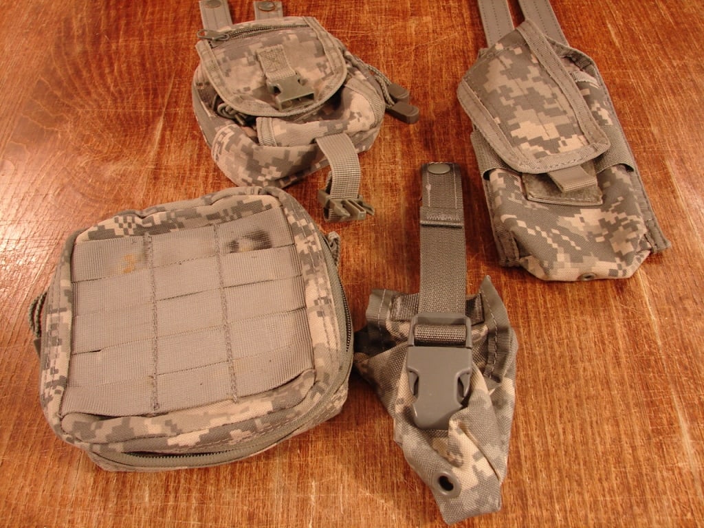 Lot of 4 camouflage US military issue pouches: Lot of 4 camouflage US military issue utility pouches with Velcro and snaps.