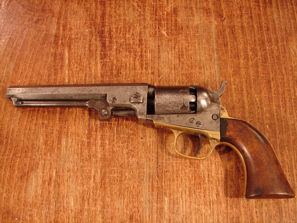 Colt Model 1849 Pocket Model Revolver: Colt Model 1849 Pocket Model Revolver. All matching serial numbers, including the wedge #273457 (1865). Desirable 6" octagonal barrel with New York address. Overall, very good, gray patina, one small