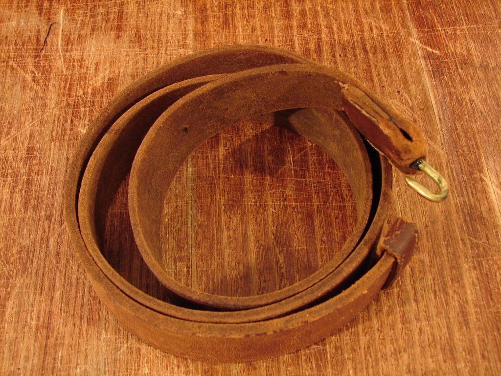 Original Un-issued Leather Civil War Musket Sling: Original Un-issued Brown Leather Civil War Musket or Rifle Sling. Unmarked, measuring 44" overall, this sling with brass hook and end loop was standard U.S. Regulation issue. It remains in excellent