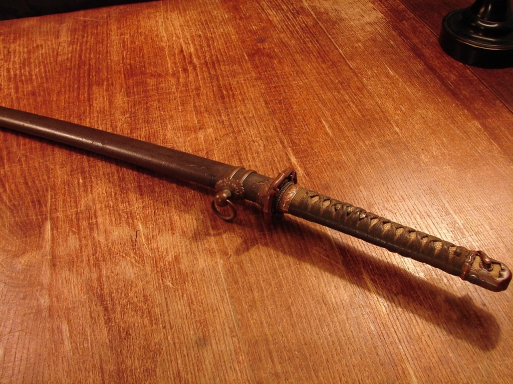 WWII Japanese Officers sword -signed: WWII Japanese signed Officers sword. Early Shin Gunto sword with scarce early copper fittings and wooden lacquered saya. Combat used with appropriate wear. This sword was made early when copper was