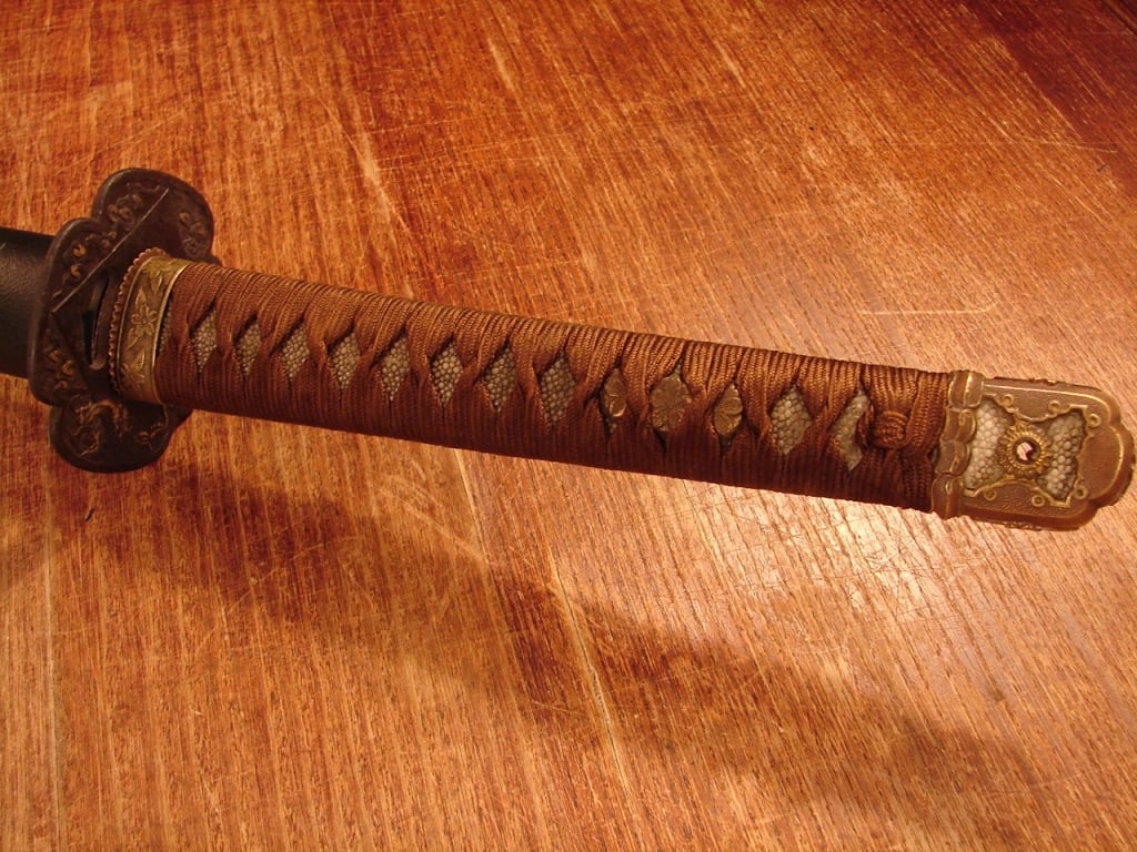 Japanese sword in WWII mounts - signed: Japanese sword with an older signed family blade. Perhaps 1800's made. Regulation Shin Gunto handle with civilian saya. Saya has been restored from presumably a wooden saya with leather combat cover.