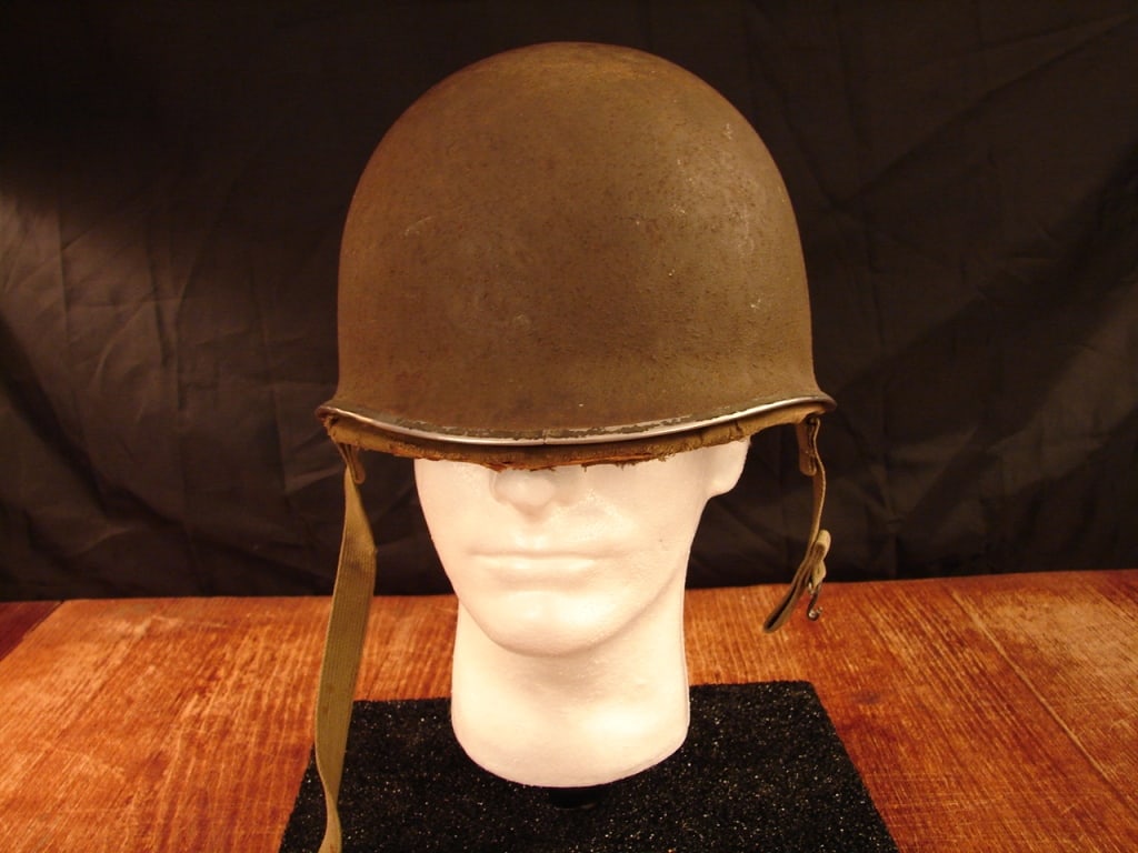 WWII US M1 Helmet with Hawley liner: Early WWII US M1 Helmet with Hawley liner. Front seam, fixed bale helmet. Typical combat use with wear to the Hawley fiber liner. Scarce liner to find in any condition.
