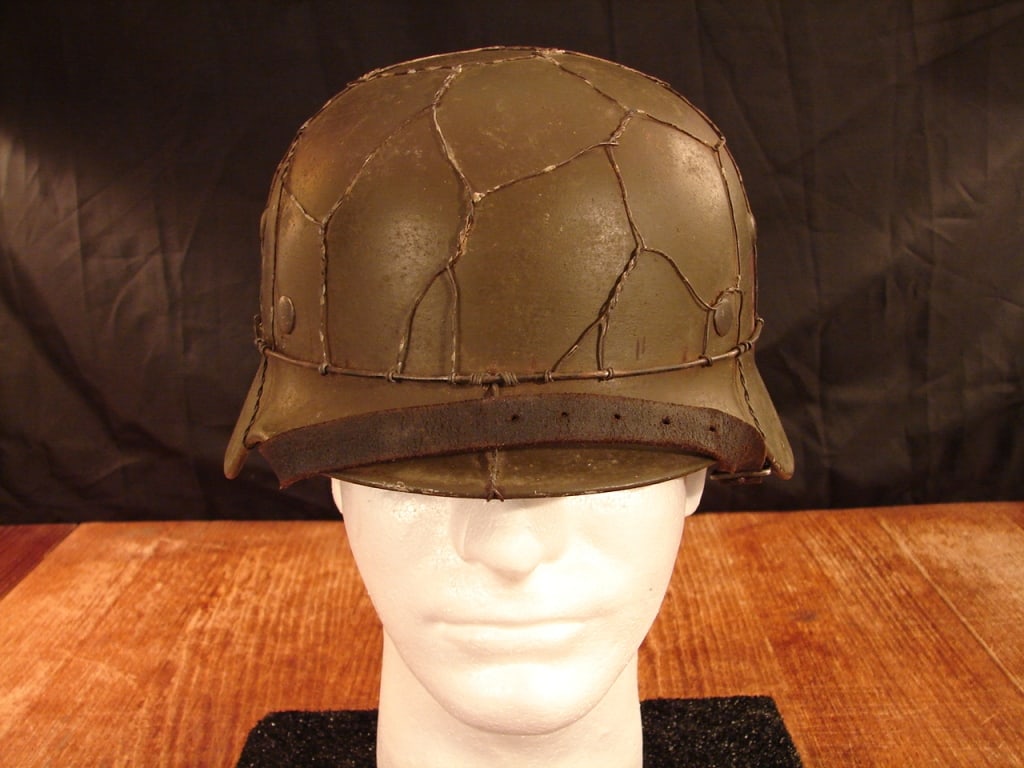 WWII German army helmet: WWII German army helmet. Shows SE 64 and lot number 3533. This helmet has been re-worked. Probably 1960's with added chicken wire and perhaps decal. Still makes a fine display helmet. See photos as