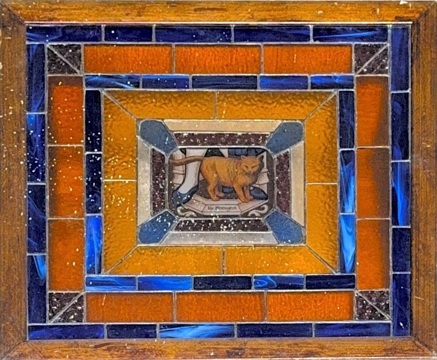 Glassmasters "Ric Whitington" Cat Suncatcher, Original Antique Stained Glass: Subject is likely inspired by the English folk tale of Dick Whittington and his cat, where a young man finds fortune in London with the help of his cat. His cat became a symbol of luck, cleverness, an