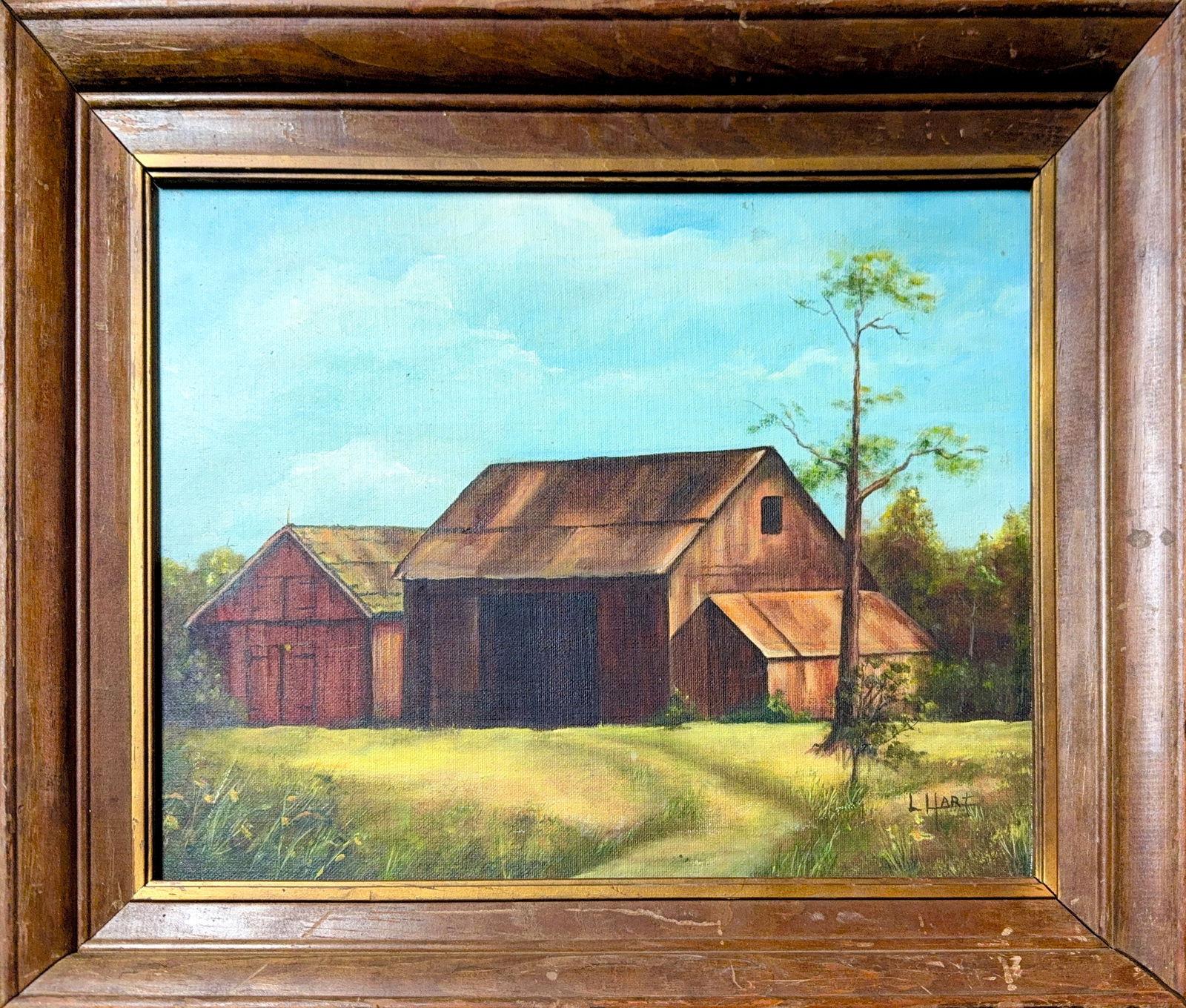 Illegible Signature, Oil on Canvas (20th Century): This framed landscape painting depicts a rustic, weathered barn set against a bright, hazy blue sky with soft white clouds. The structure features a large central barn with a dark, open interior and s