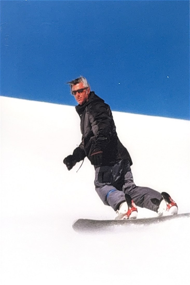 Snowboarder, Photograph Art: KEYWORDS: Male snowboarder, snowy slope, high altitude, natural lighting, winter sports, outdoor adventure. This photograph captures a snowboarder in a Heelside turn stance. This specific riding posit