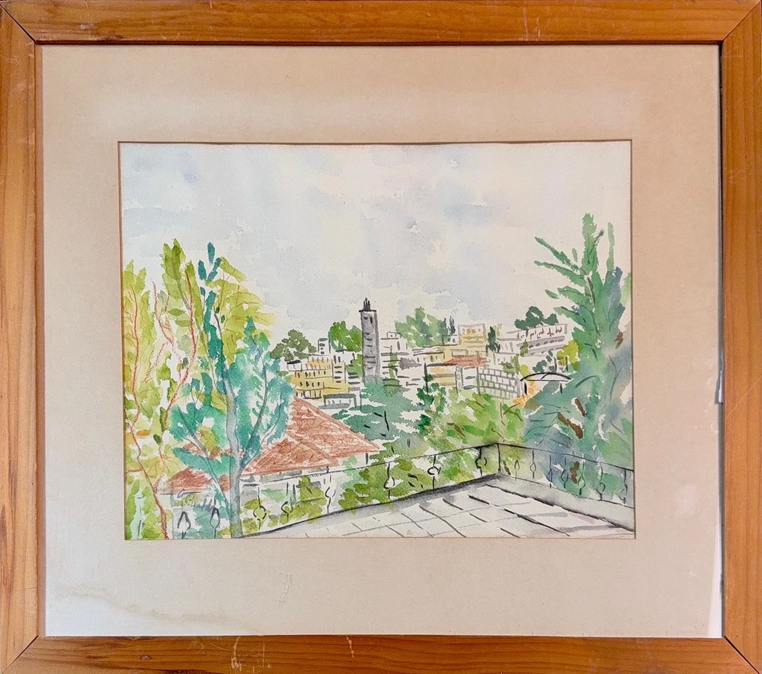 Illegible Signature, Watercolor on Paper (20th Century): This watercolor and ink painting depicts a sunlit urban landscape viewed from an elevated perspective, likely a balcony or terrace. The composition features a foreground terrace with a dark, simple ra