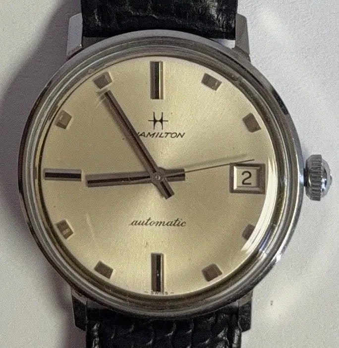 Hamilton Dateline From 1960s Automatic Watch: Title: Hamilton Dateline From 1960s Automatic Watch. Medium: Stainless Steel. Dimensions: Approximately 36 mm wide, 41 mm lug-to-lug. Condition: Very good Antique Conditions. Comes with Brand New Blac