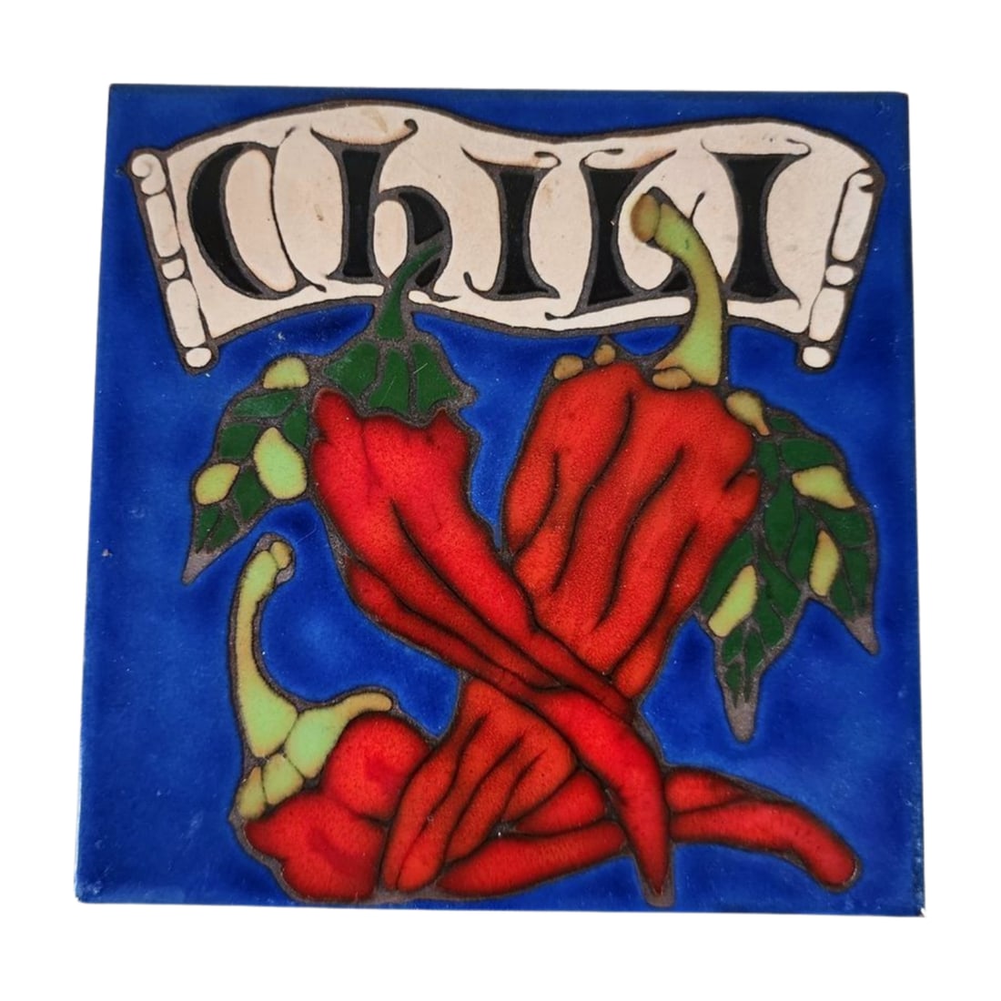 Triton Tile Hand-Glazed Chili Peppers Tile: Hand-glazed Triton Tile featuring vibrant chili peppers on a bold blue background. Labeled on the back as "Originally Designed and Hand-Glazed in the USA." Measures 5 3/8" x 5 3/8".