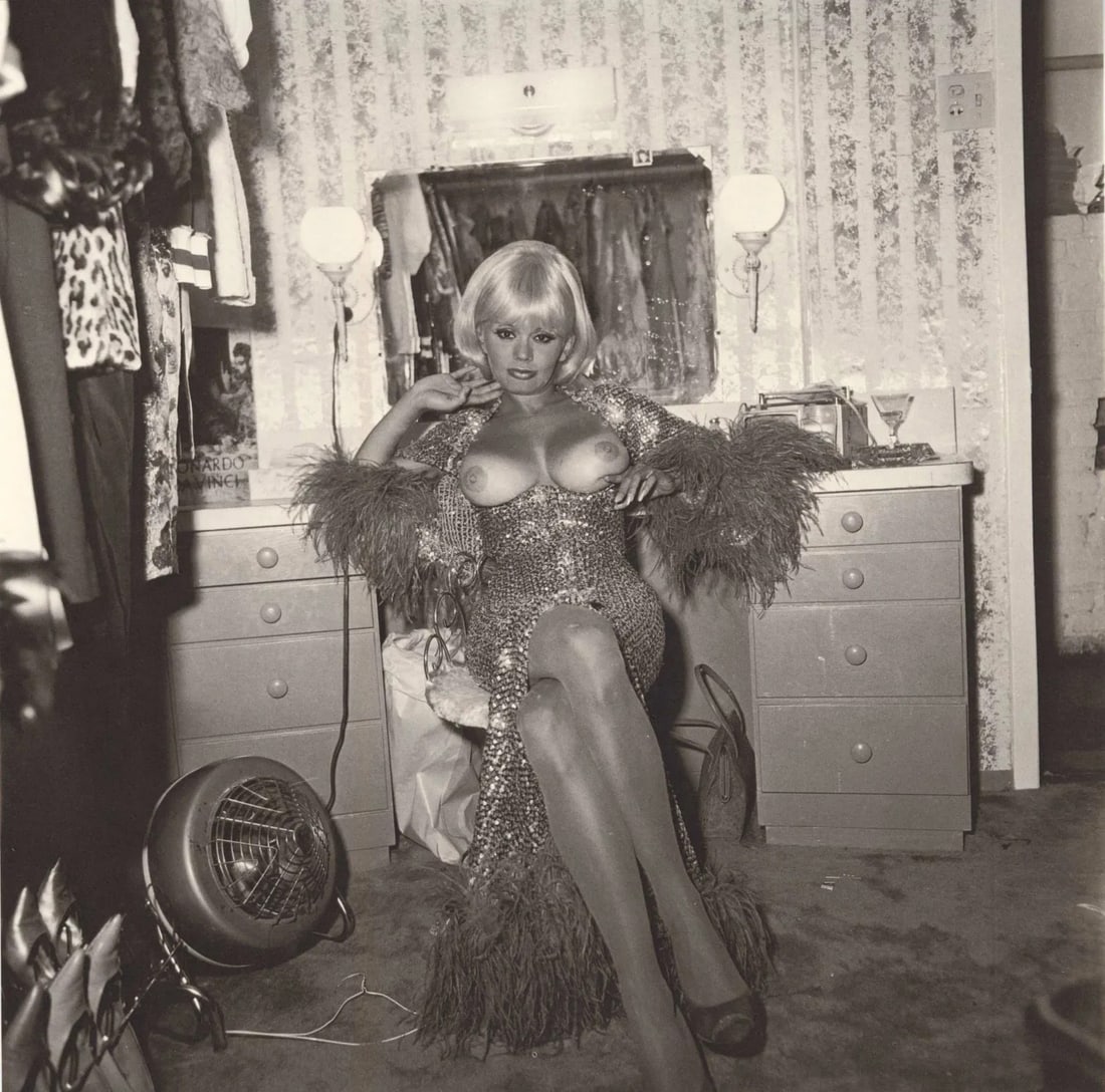 Diane Arbus (American, 1923-1971): Diane Arbus (American, 1923-1971). Topless Dancer in Her Dressing Roon, San Francisco, CA, "1968" Print. Printed in 1972. 8.25 x 8.35 inches. Please be aware that all lots in our auctions are sold "AS