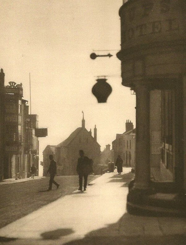 Hoppe, E.O. (British,1878-1972 ) Print: Hoppe, E. O. (British,1878-1972 ) Print. O. (British,1878-1972 ) Print. High street in Lyme Regis. Dorsetshire. Printed in 1926. 6.00 x 8.00 inches. Please be aware that all lots in our auctions are
