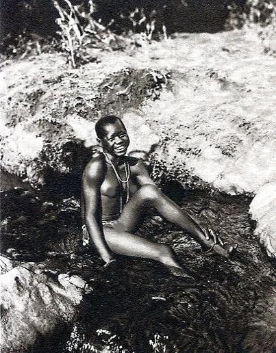 Joseph Steinlehner Print: Joseph Steinlehner Print. Mdjagga Girl, Kenya. Printed in 1926. 3.5 x 4.5 inches. Not hand-signed unless otherwise stated. Photomechanical Print. Lots that contain nudity have been partially obscured