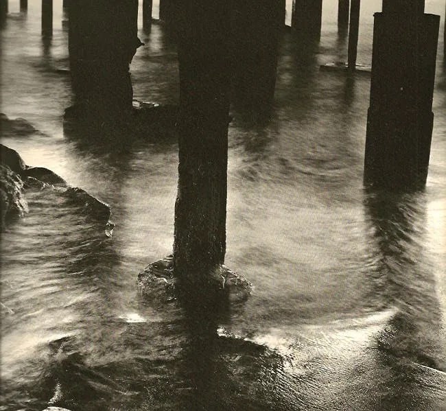 Wynn Bullock (American, 1902-1975) Print: Wynn Bullock (American, 1902-1975) Print. Pilings. Printed in 1971. 9.50 x 7.50 inches Not hand-signed unless otherwise stated. Photomechanical Print. Lots that contain nudity have been partially obsc
